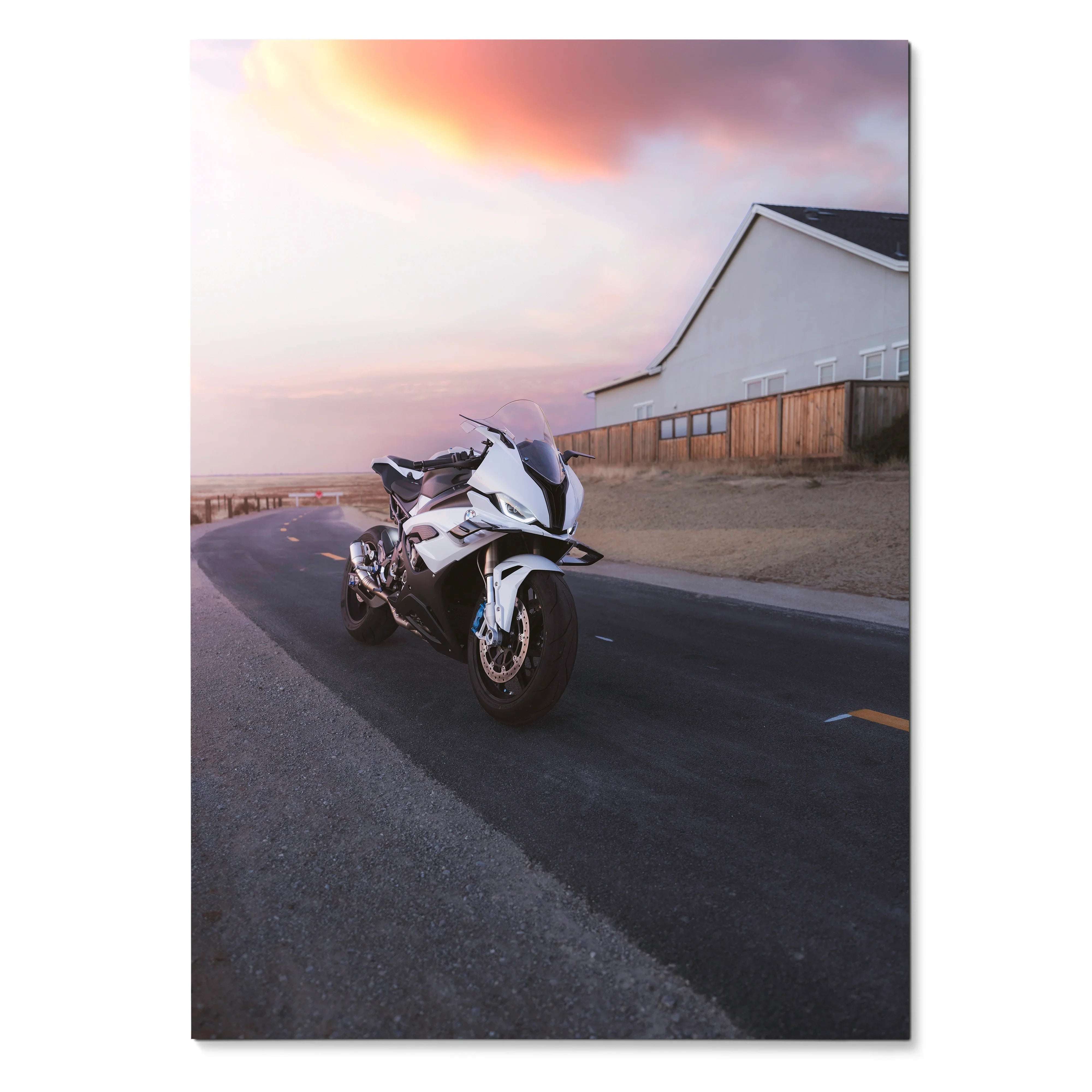 BMW S1000RR motorcycle parked on road at sunset poster wall art in soft pink sky.