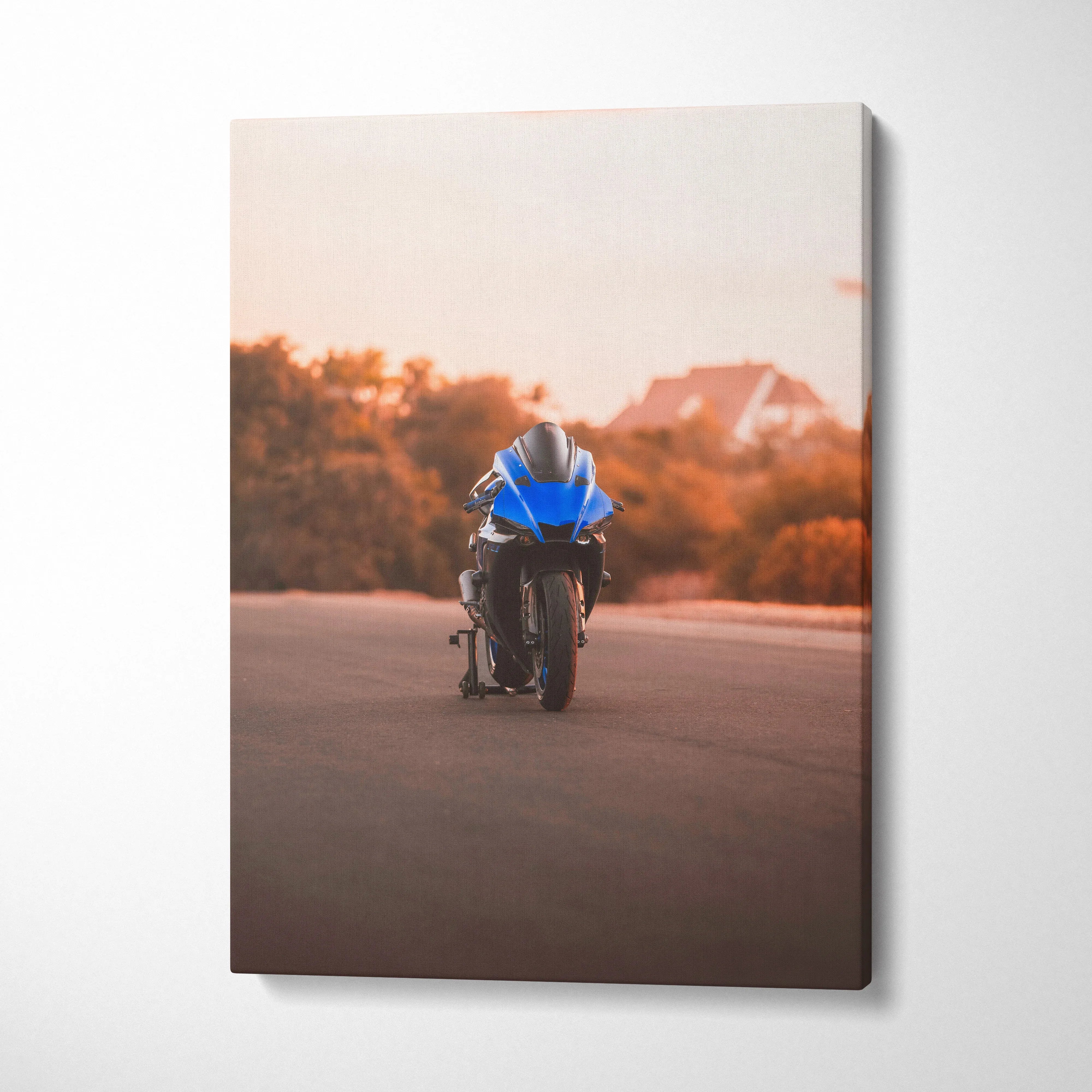 Yamaha R1 motorcycle on road at sunset canvas wall art with warm orange sky background.