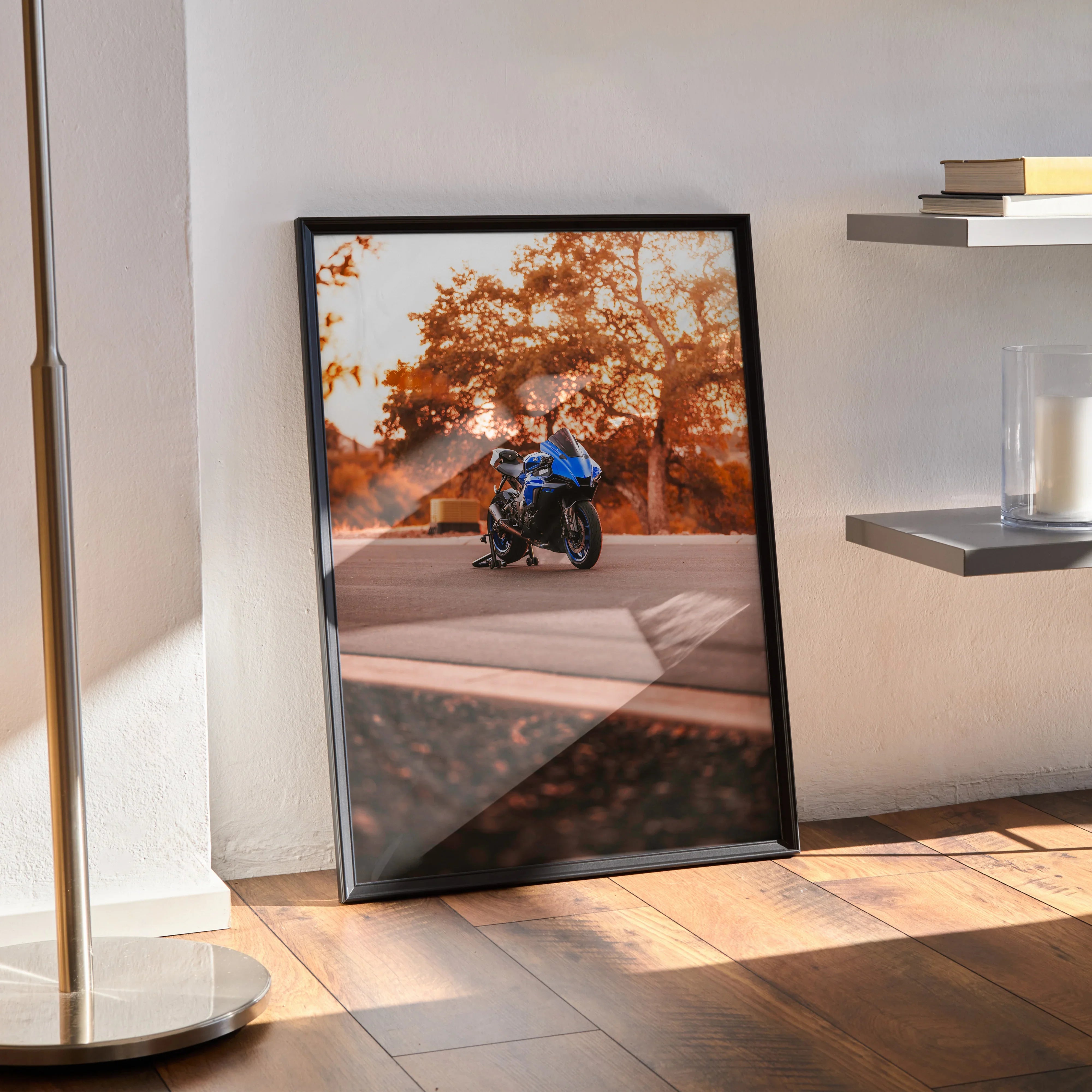 Yamaha R1 motorcycle poster with autumn trees and road, framed wall art leaning on floor.