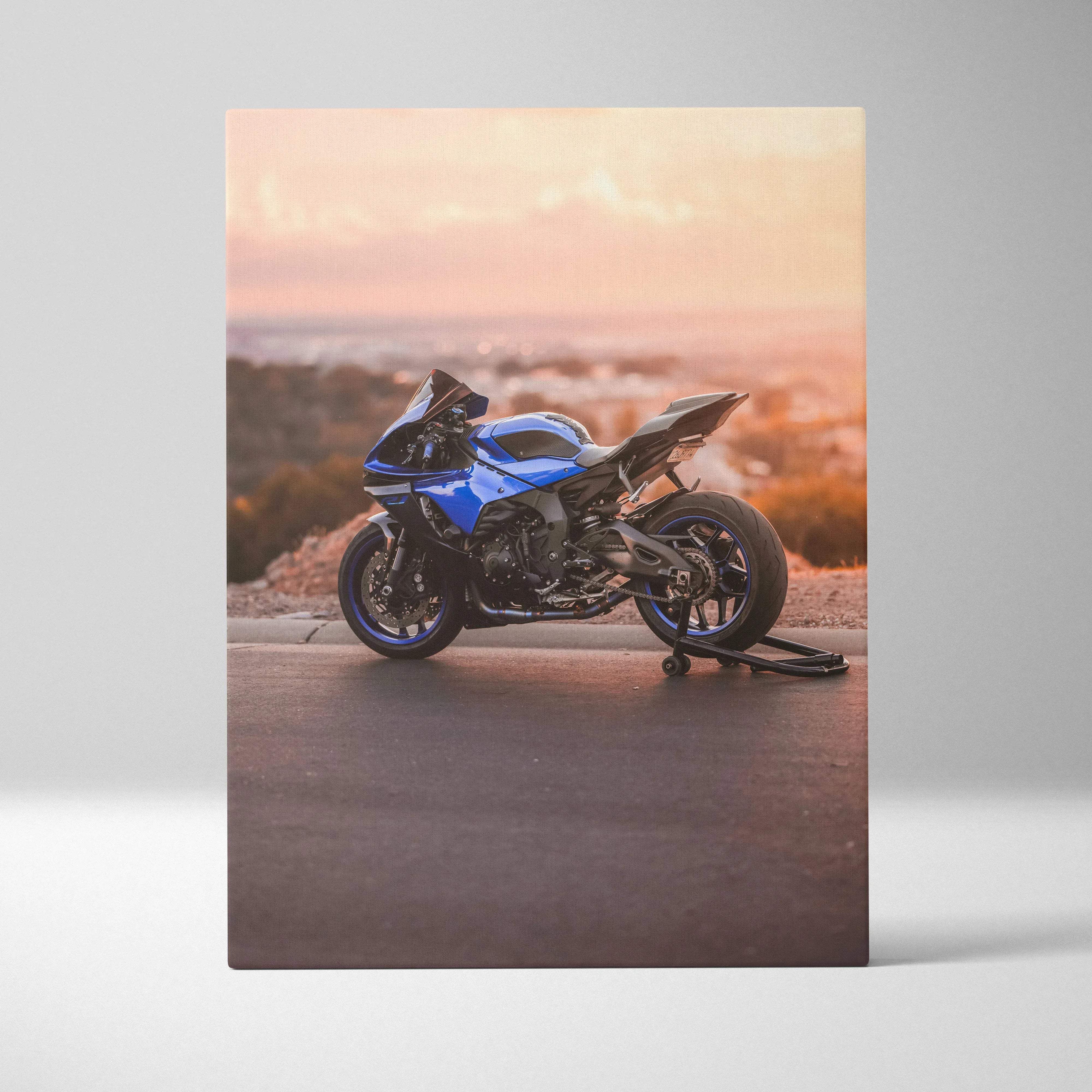 Blue Yamaha R1 motorcycle canvas wall art with sleek aerodynamic design and black accents at sunset on paved surface