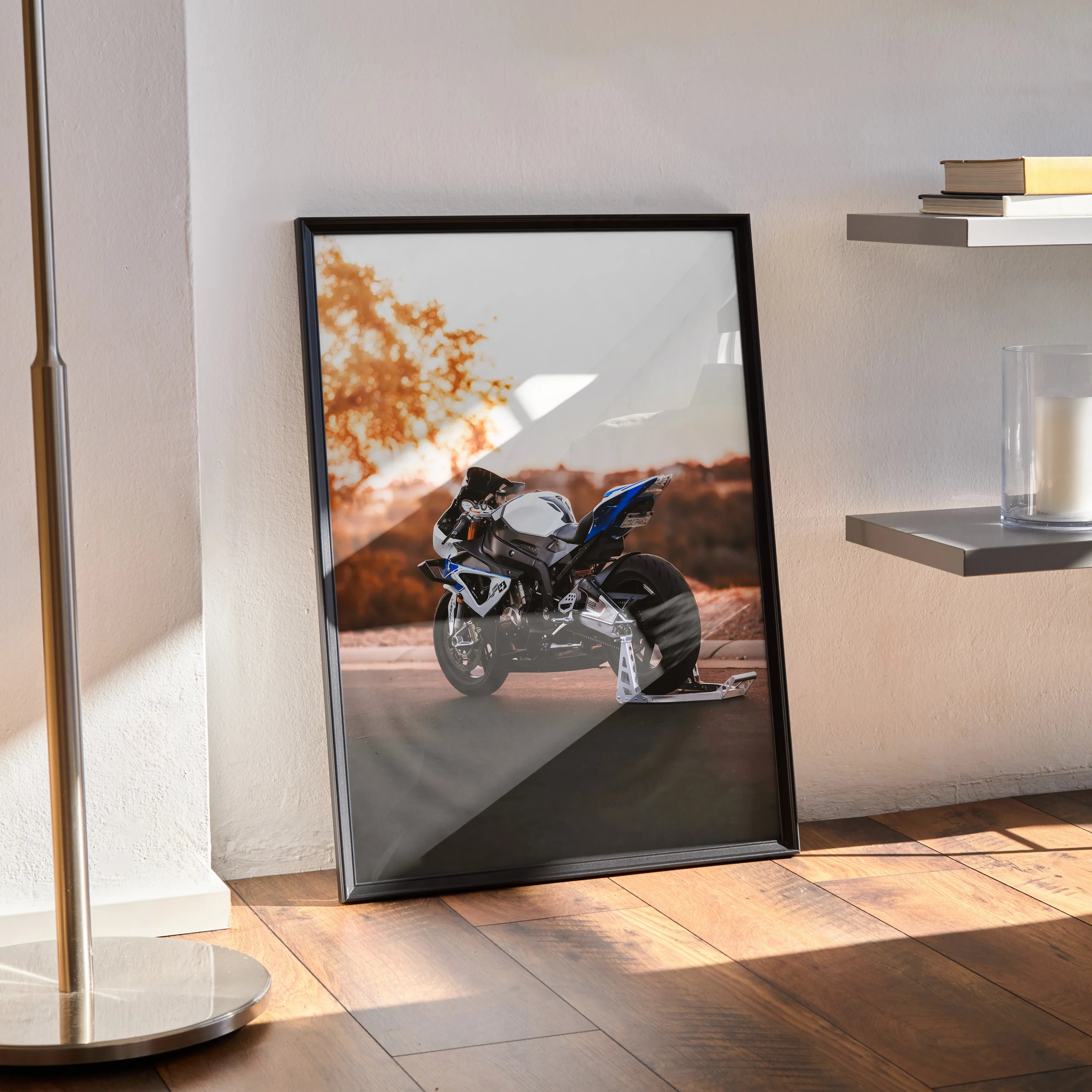 BMW S1000RR HP4 motorcycle poster with black frame, displayed as wall art in bright room with wooden floor and shelves.