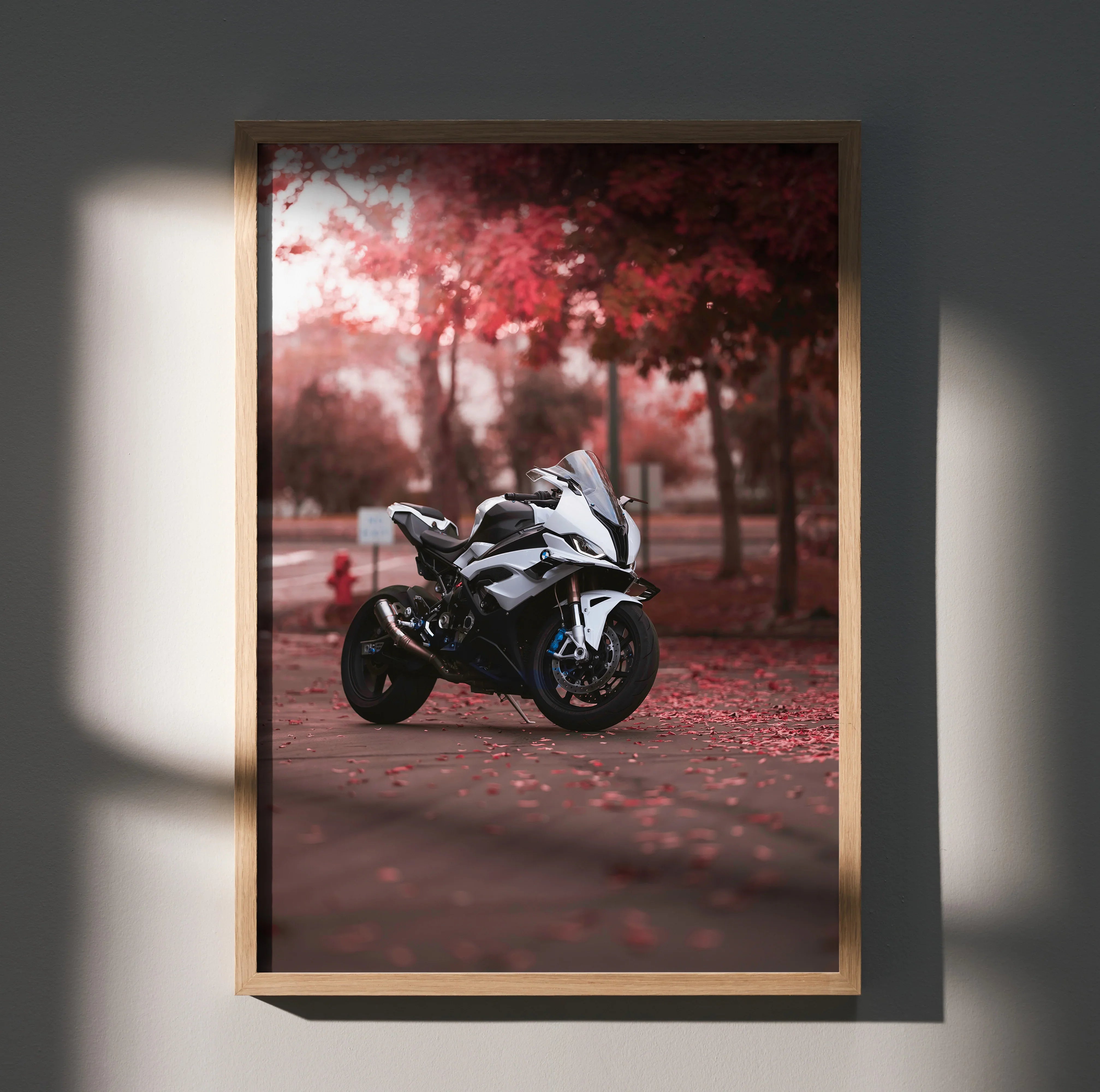BMW S1000RR motorcycle poster with red autumn leaves, stylish wall art in wooden frame.