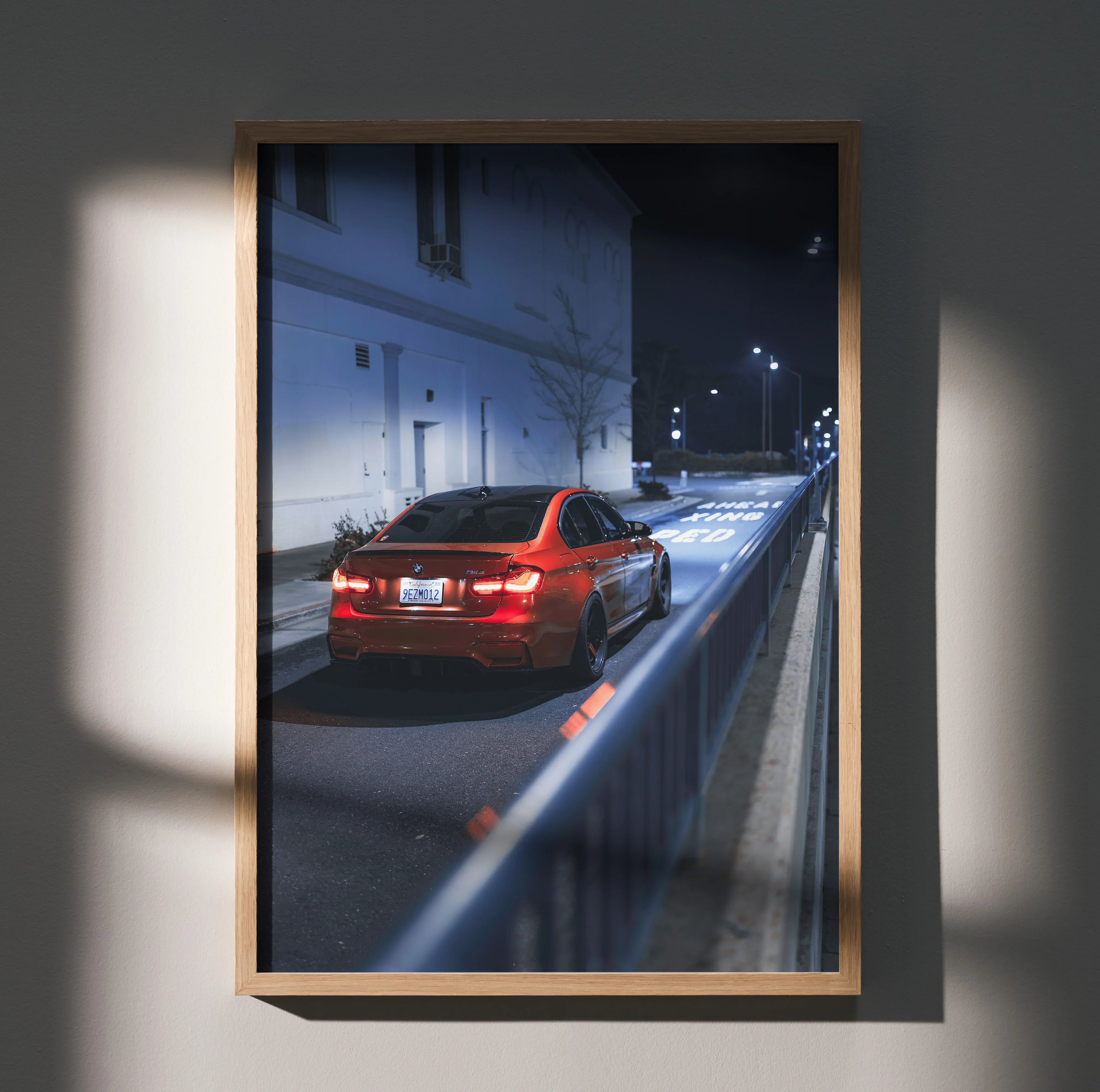 BMW F80 M3 driving at night with illuminated taillights poster wall art in wooden frame.
