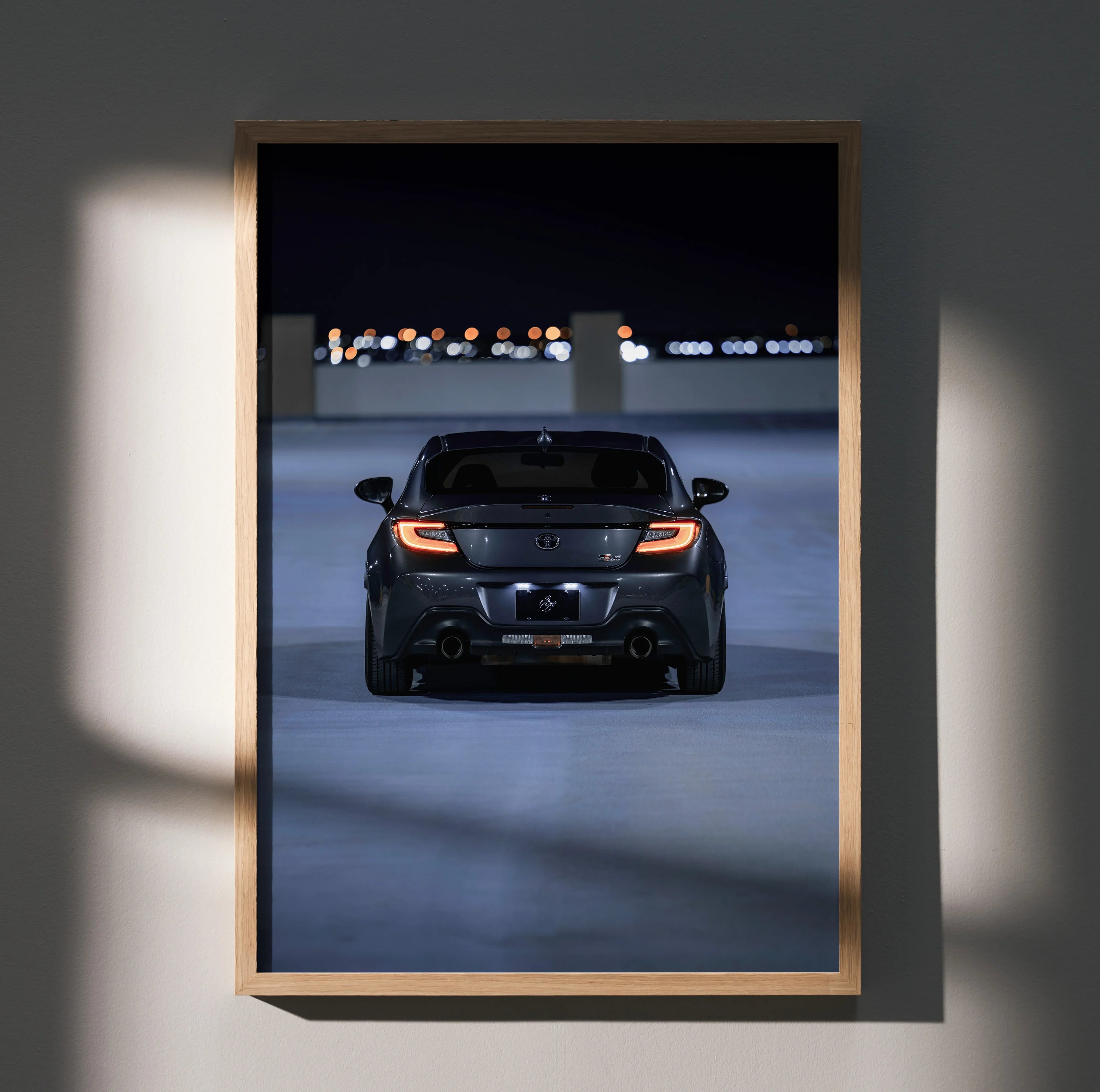 Toyota GR86 rear view poster with dark background, sleek design wall art in wooden frame.