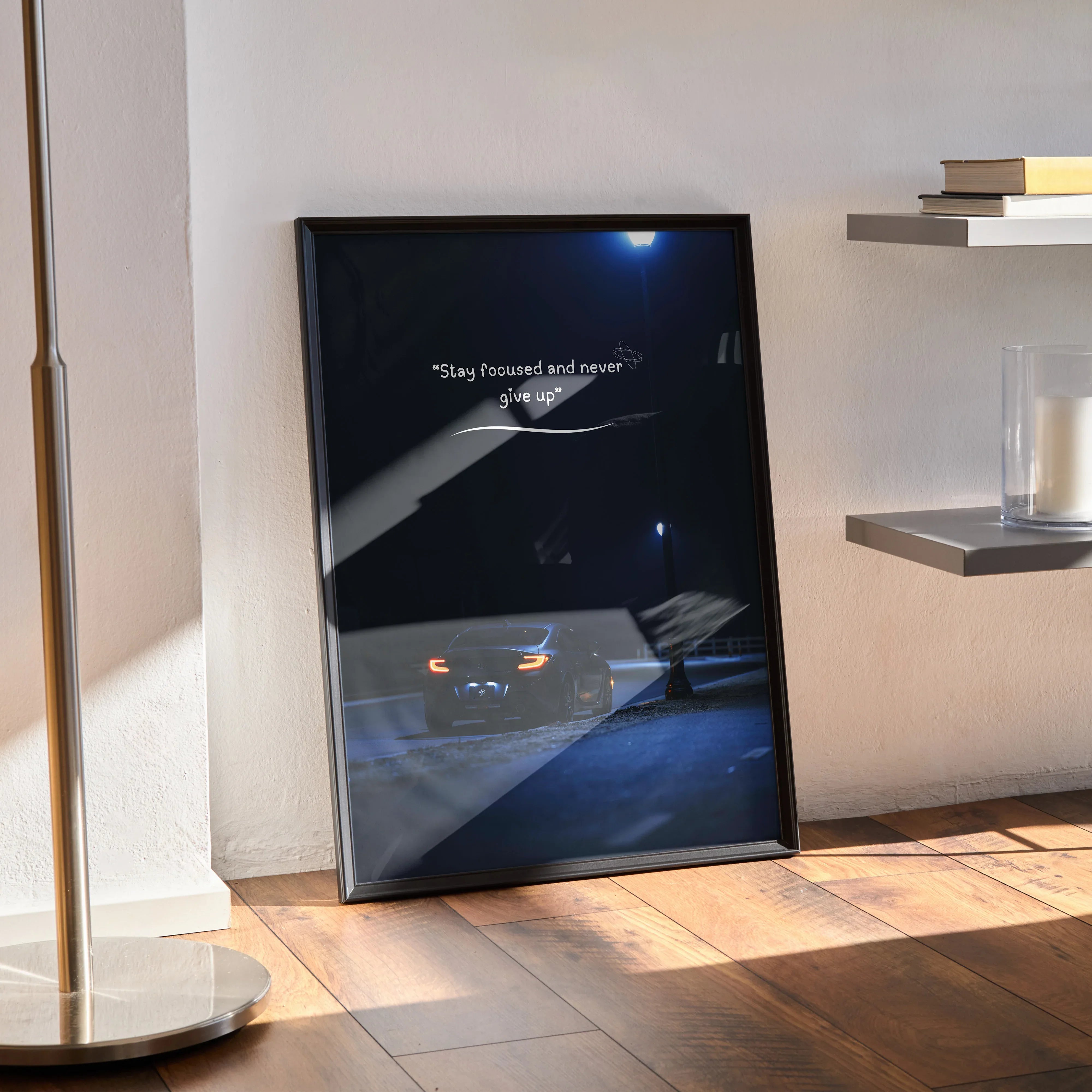 Toyota GR86 motivational poster with inspiring text, black frame wall art on wooden floor.