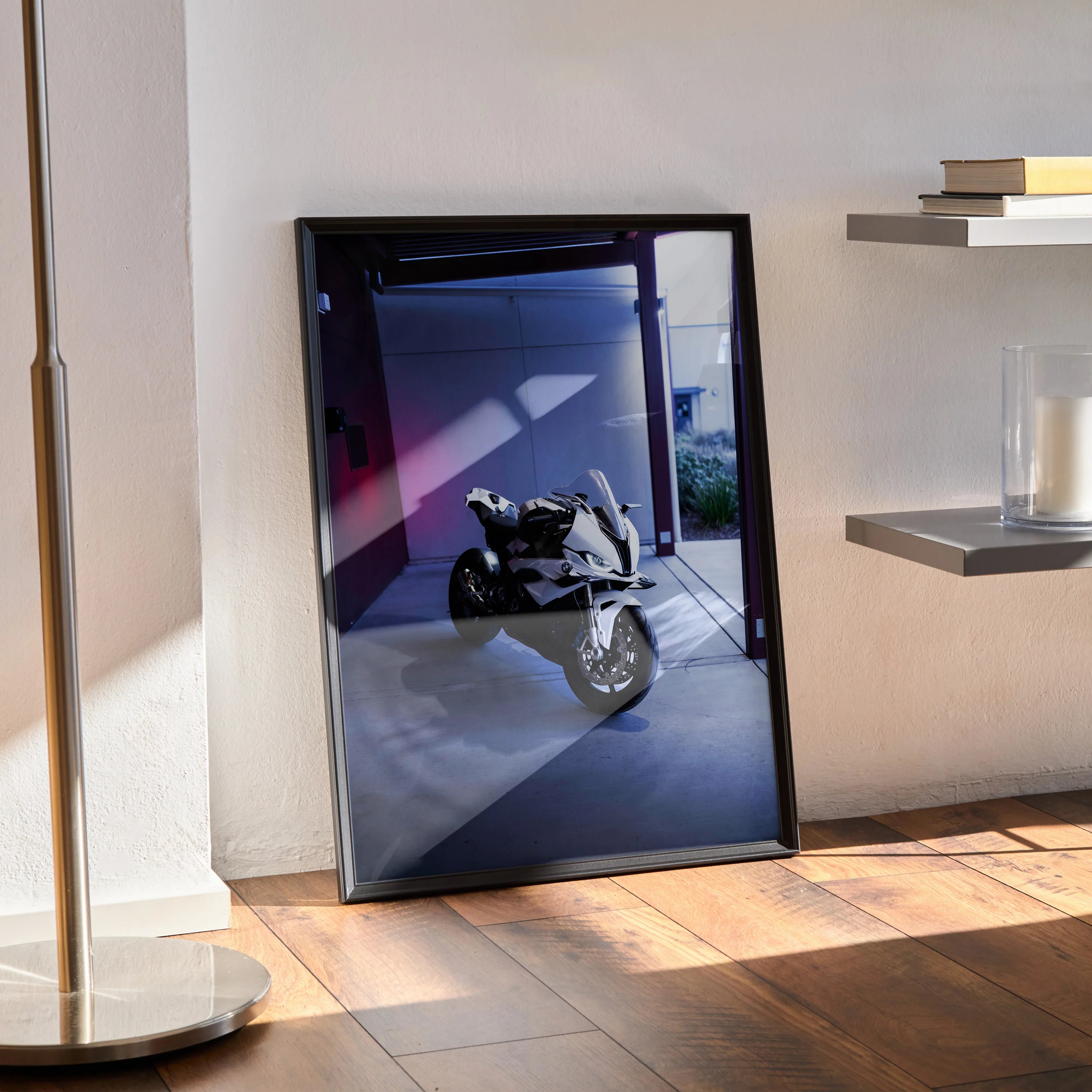 Framed BMW S1000RR motorcycle poster leaning against wall with modern interior background wall art.