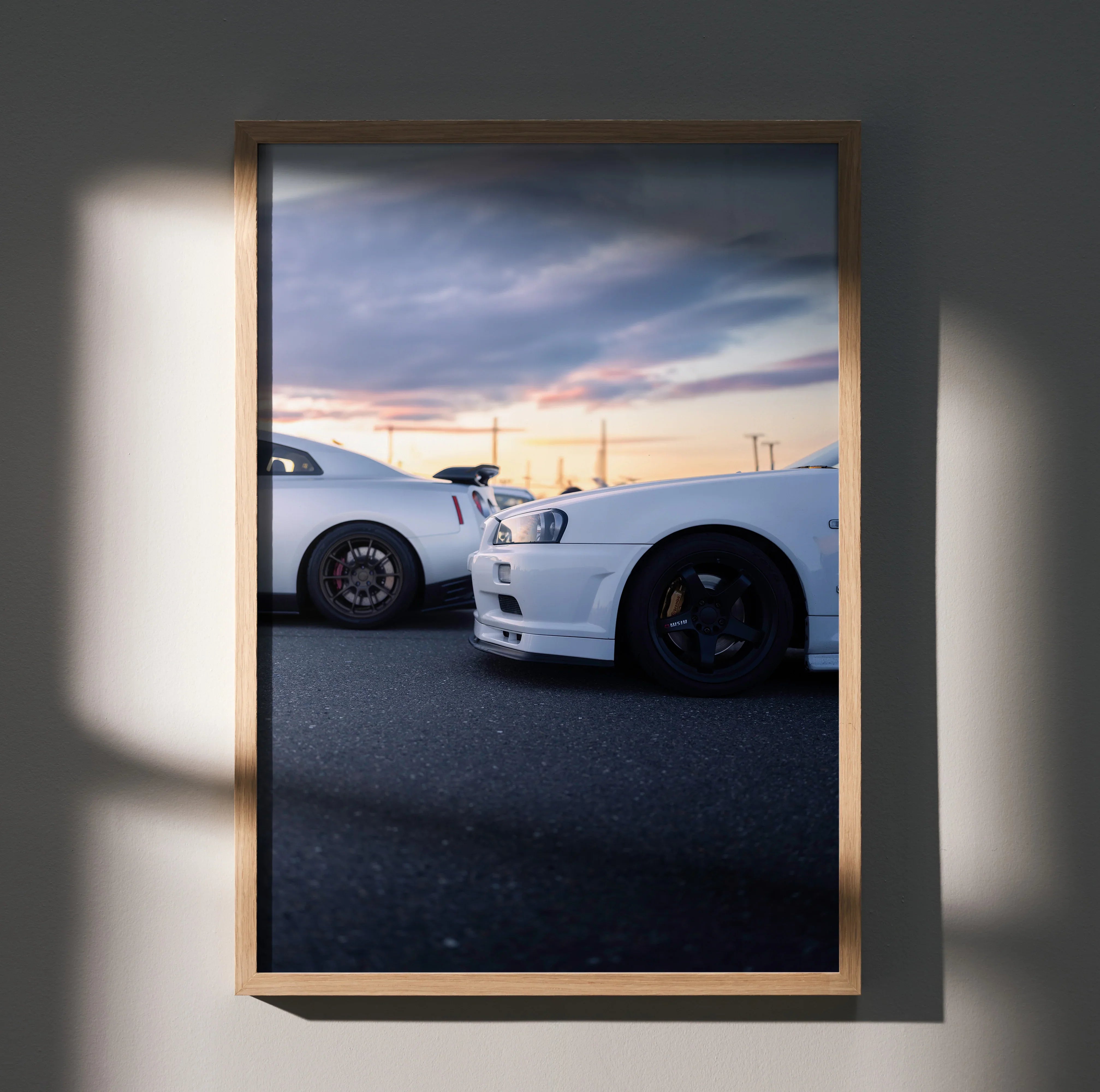 Nissan GTR R34 Skyline poster wall art with two white cars side view at sunset in wooden frame.