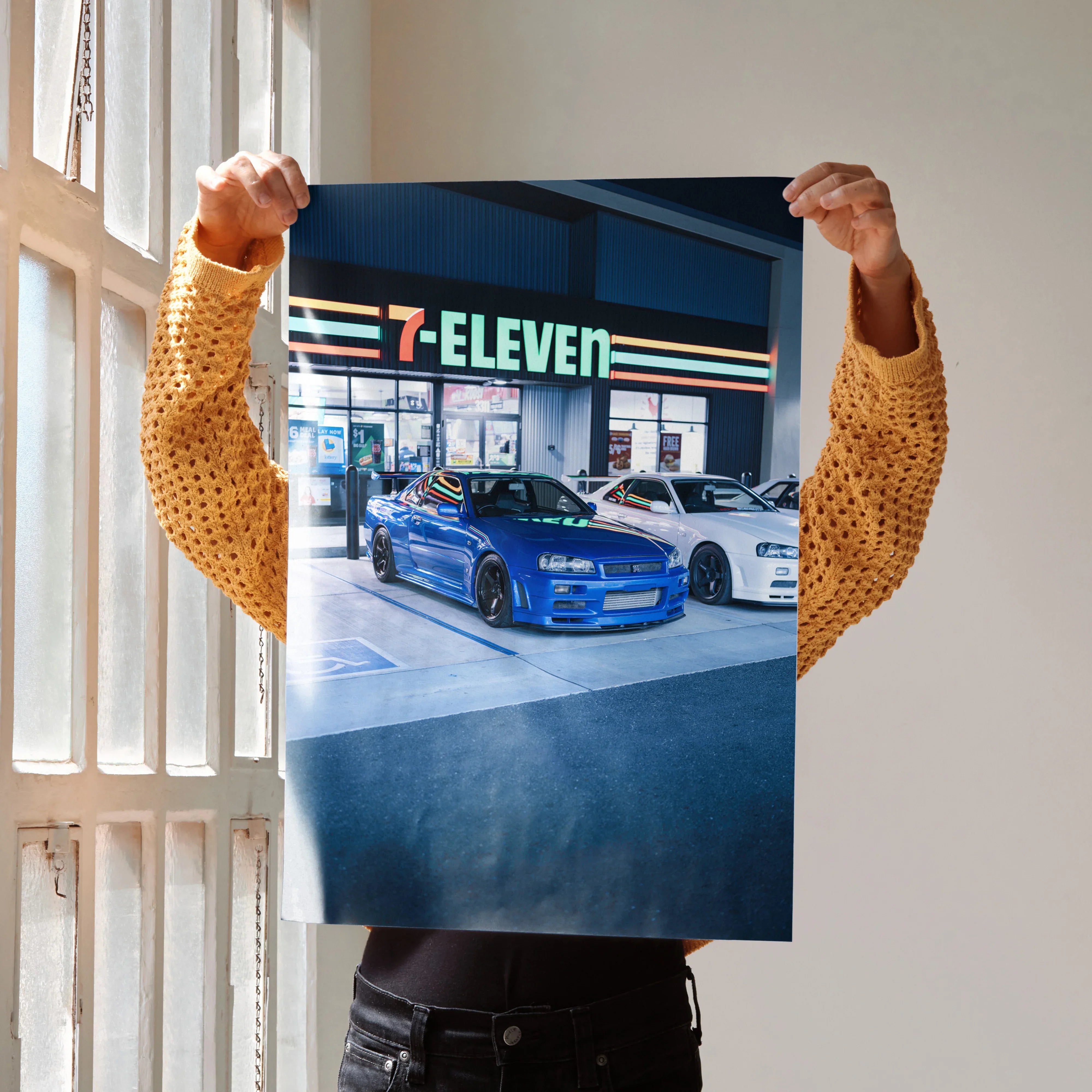 Nissan GTR R34 Skyline poster wall art featuring blue and white cars parked outside 7-Eleven at night.