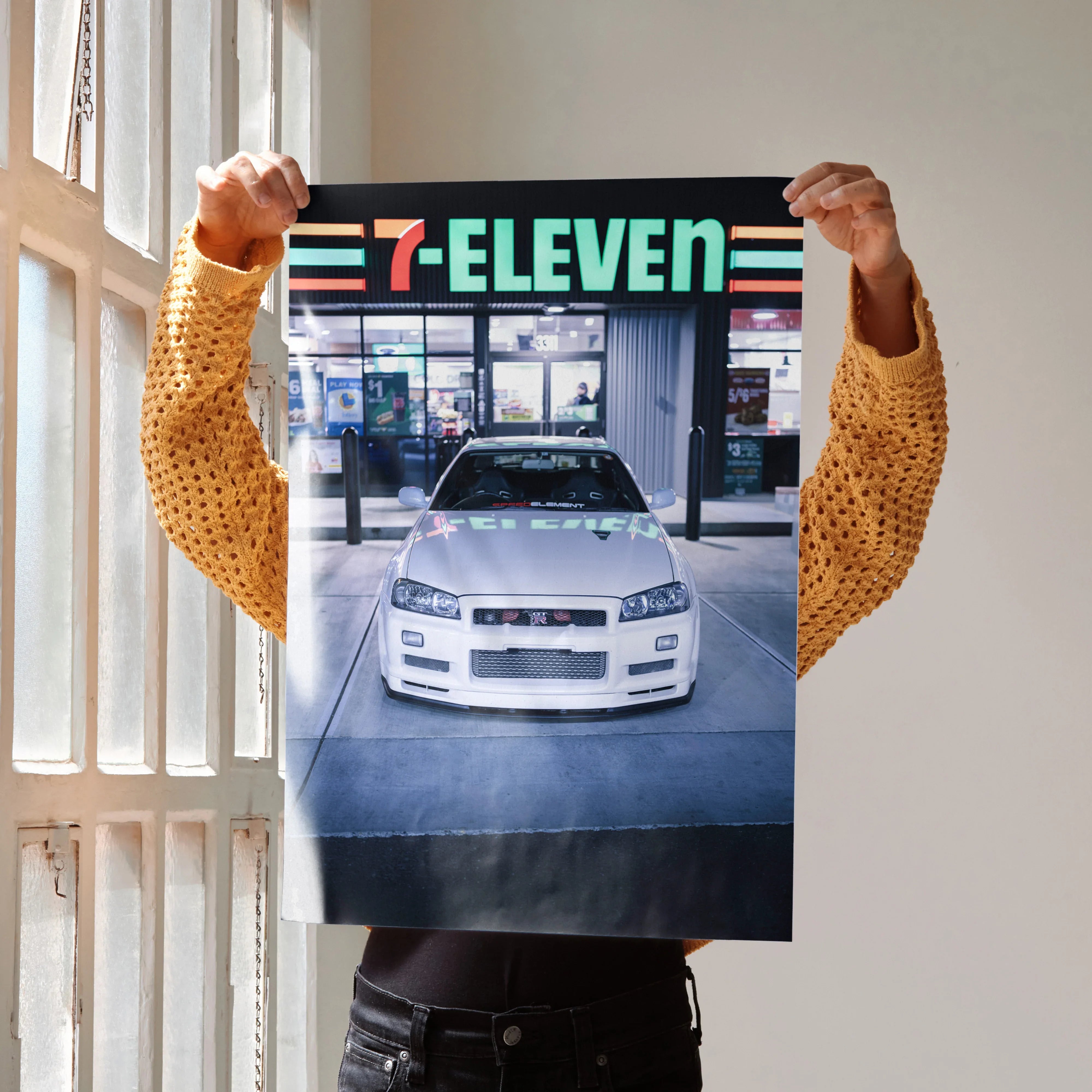 Nissan GTR R34 Skyline poster showing front view of white sports car at gas station, high-resolution wall art.