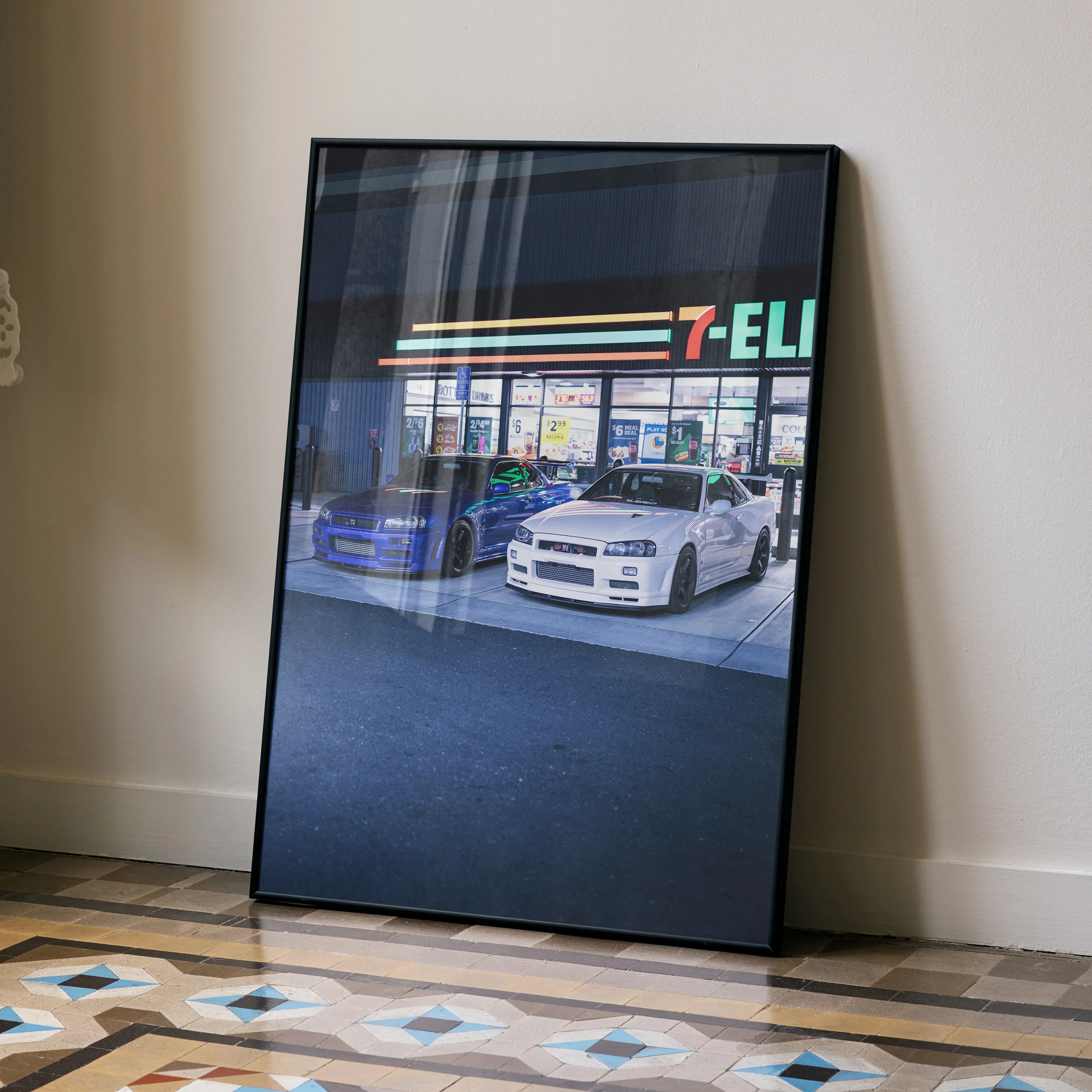 Nissan GTR R34 Skyline poster wall art with white car parked at 7-Eleven gas station at night.
