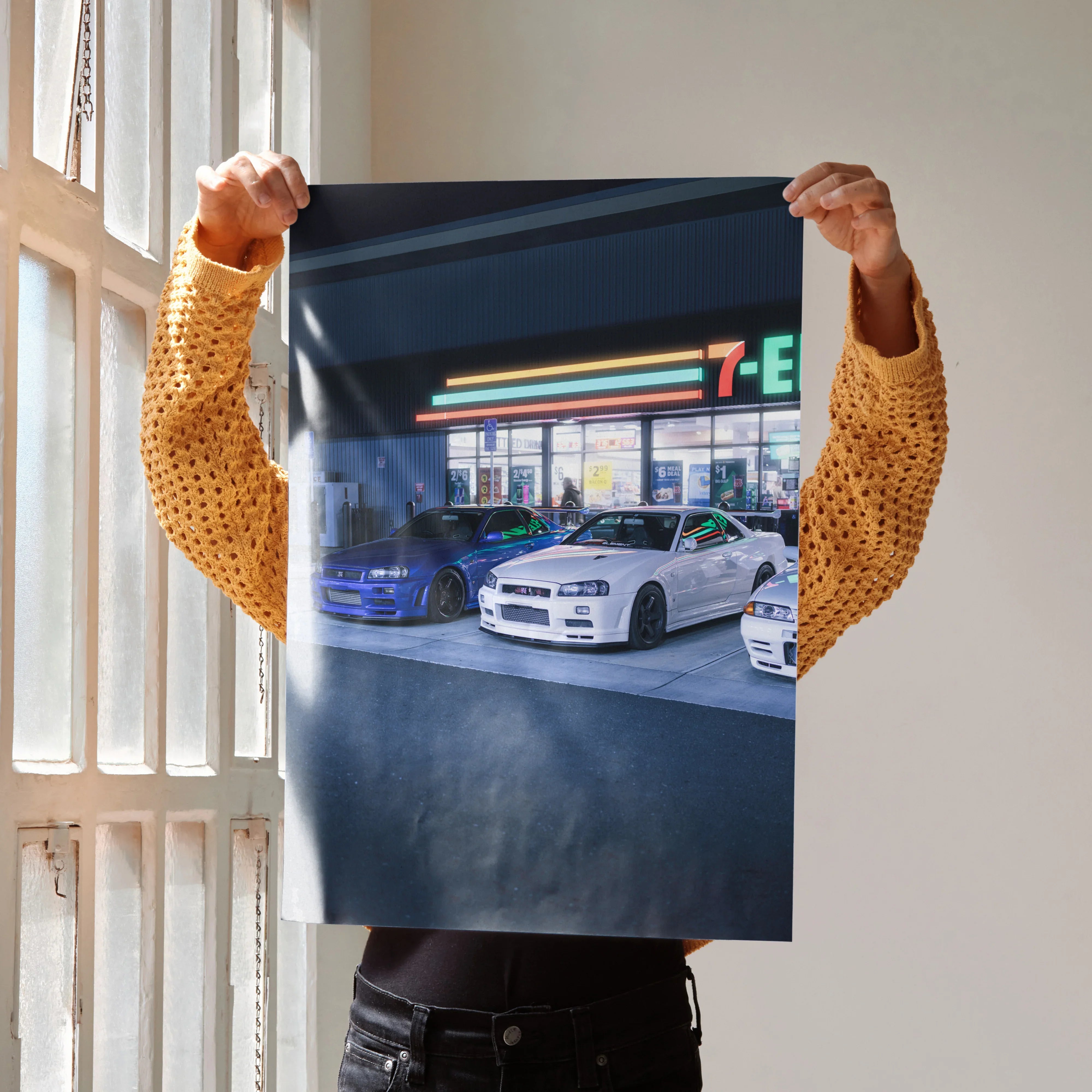 Poster wall art featuring Nissan GTR R34 Skyline parked in front of a 7-Eleven at night.