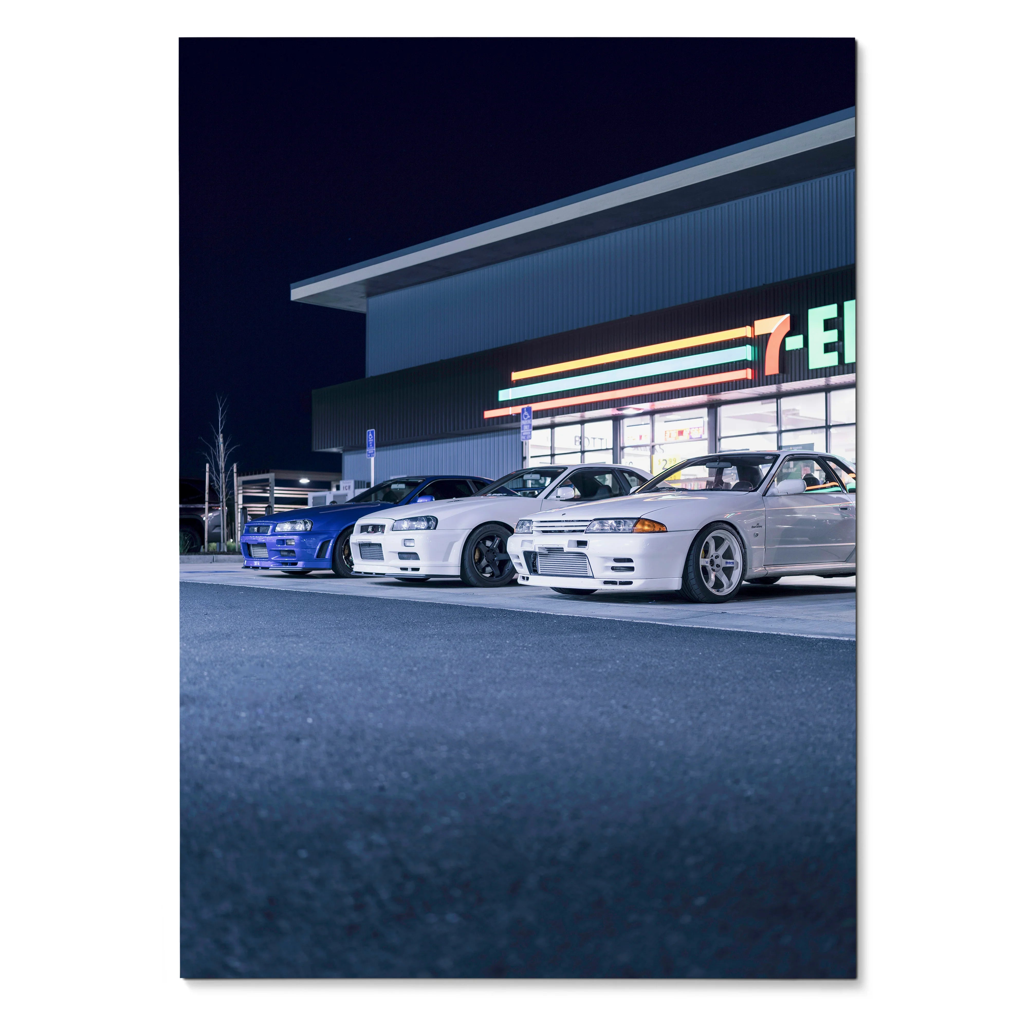 Poster wall art featuring high-resolution Nissan R32 and R34 GTR Skyline cars parked at night.