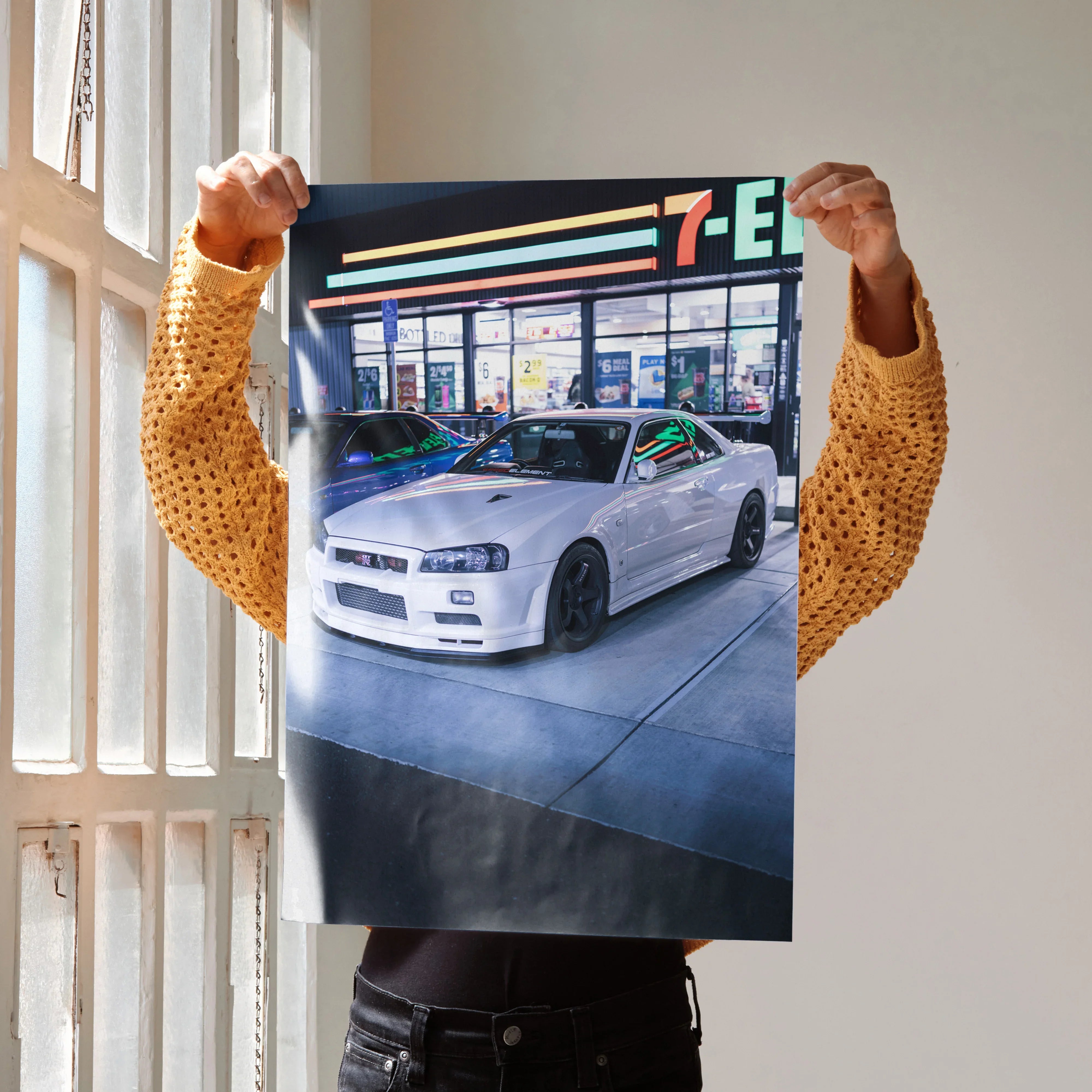 Nissan R34 GTR white sports car parked outside 7-Eleven poster wall art.