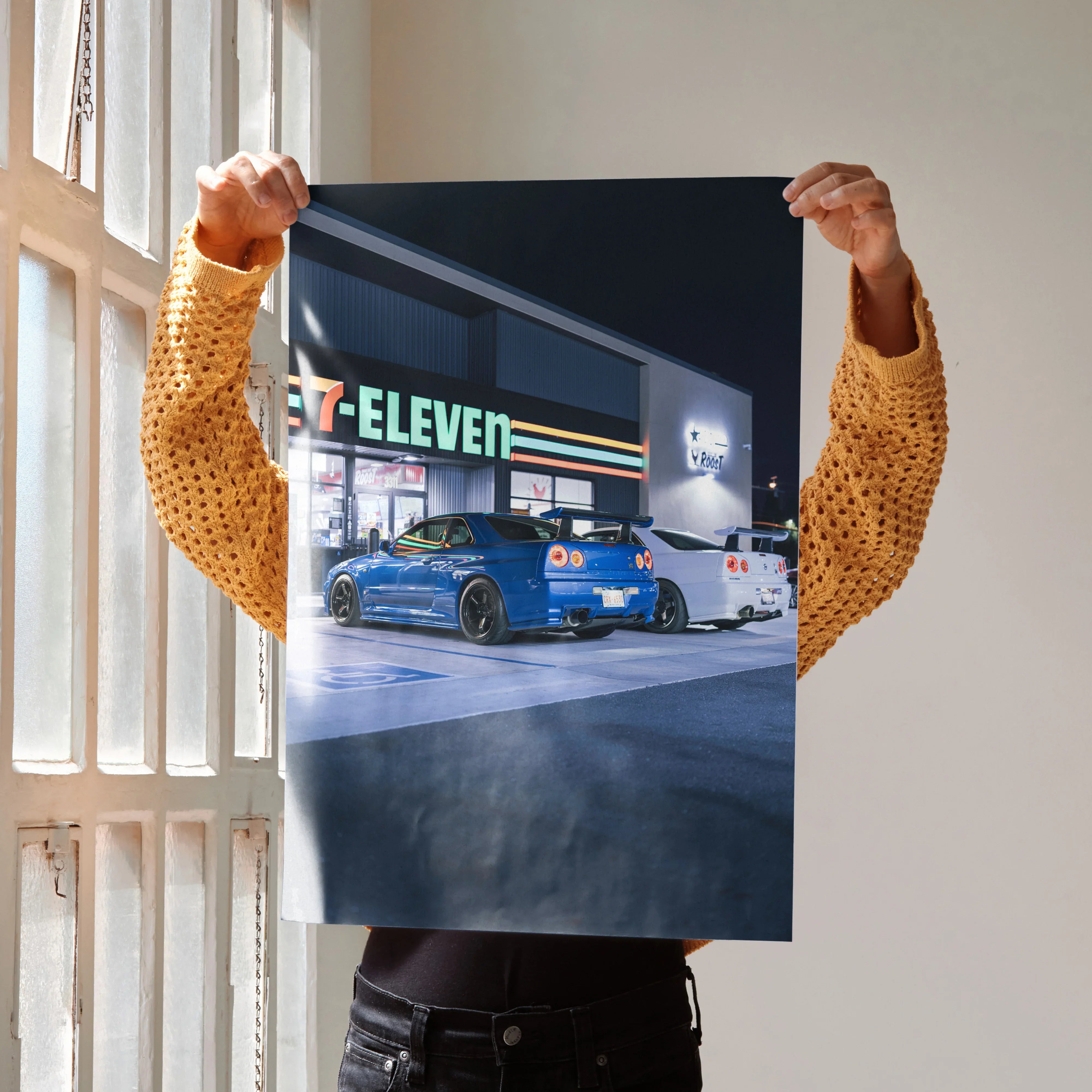 Nissan GTR R34 Skyline blue and white cars parked outside 7-Eleven at night poster wall art.