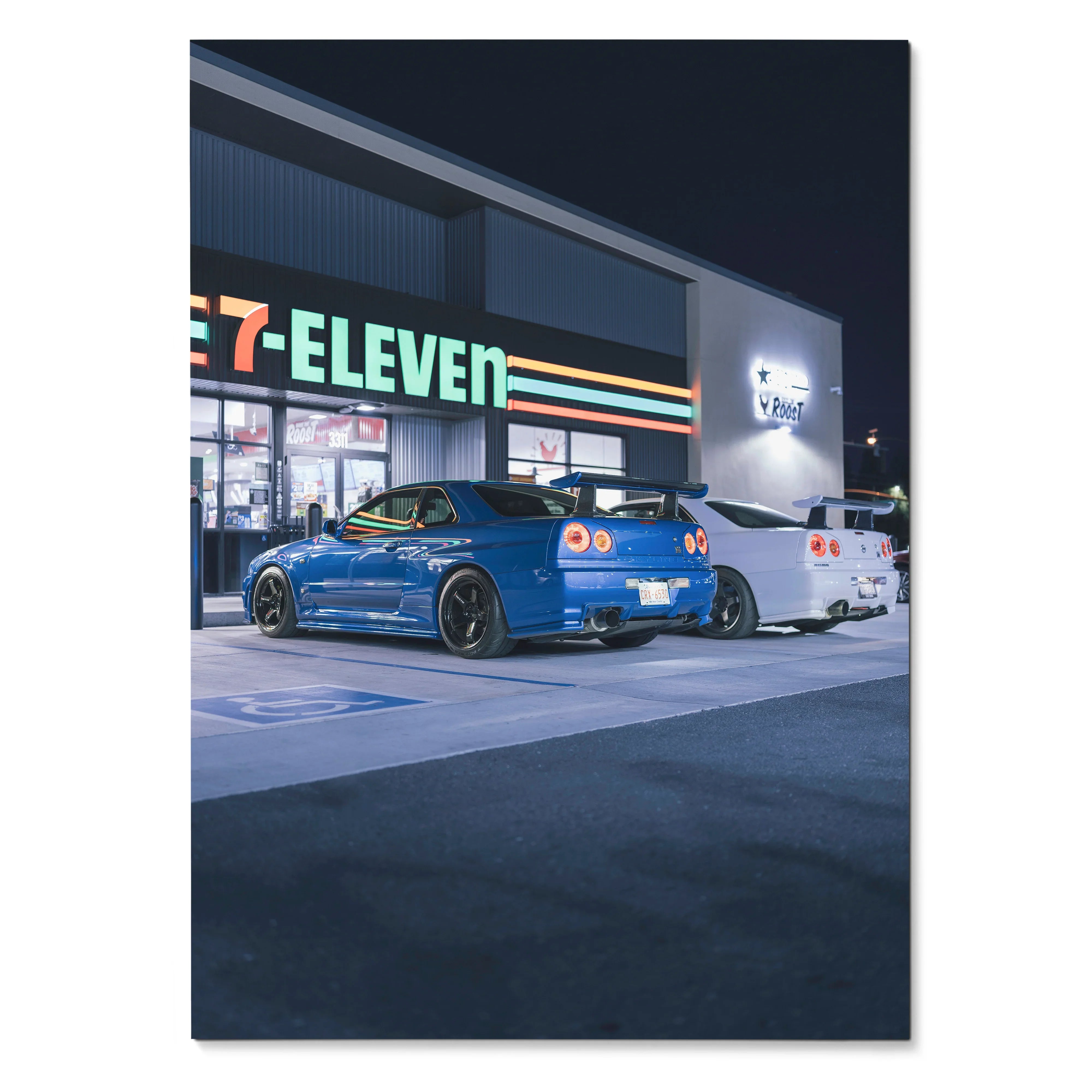 Nissan R34 GTR blue sports car parked at night outside 7-Eleven poster wall art.