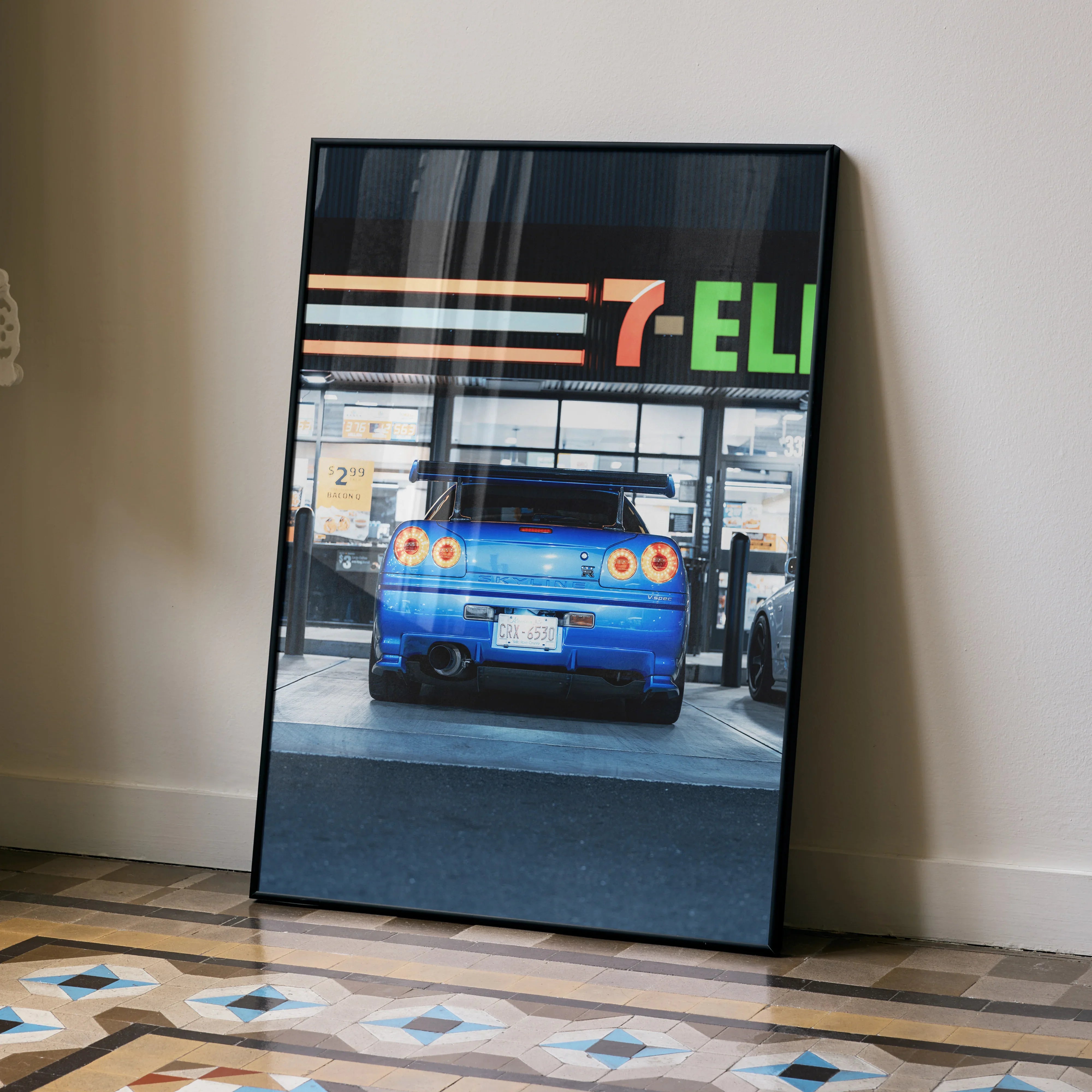 Blue Nissan GTR R34 Skyline rear view poster leaning on wall with 7-Eleven sign, wall art.