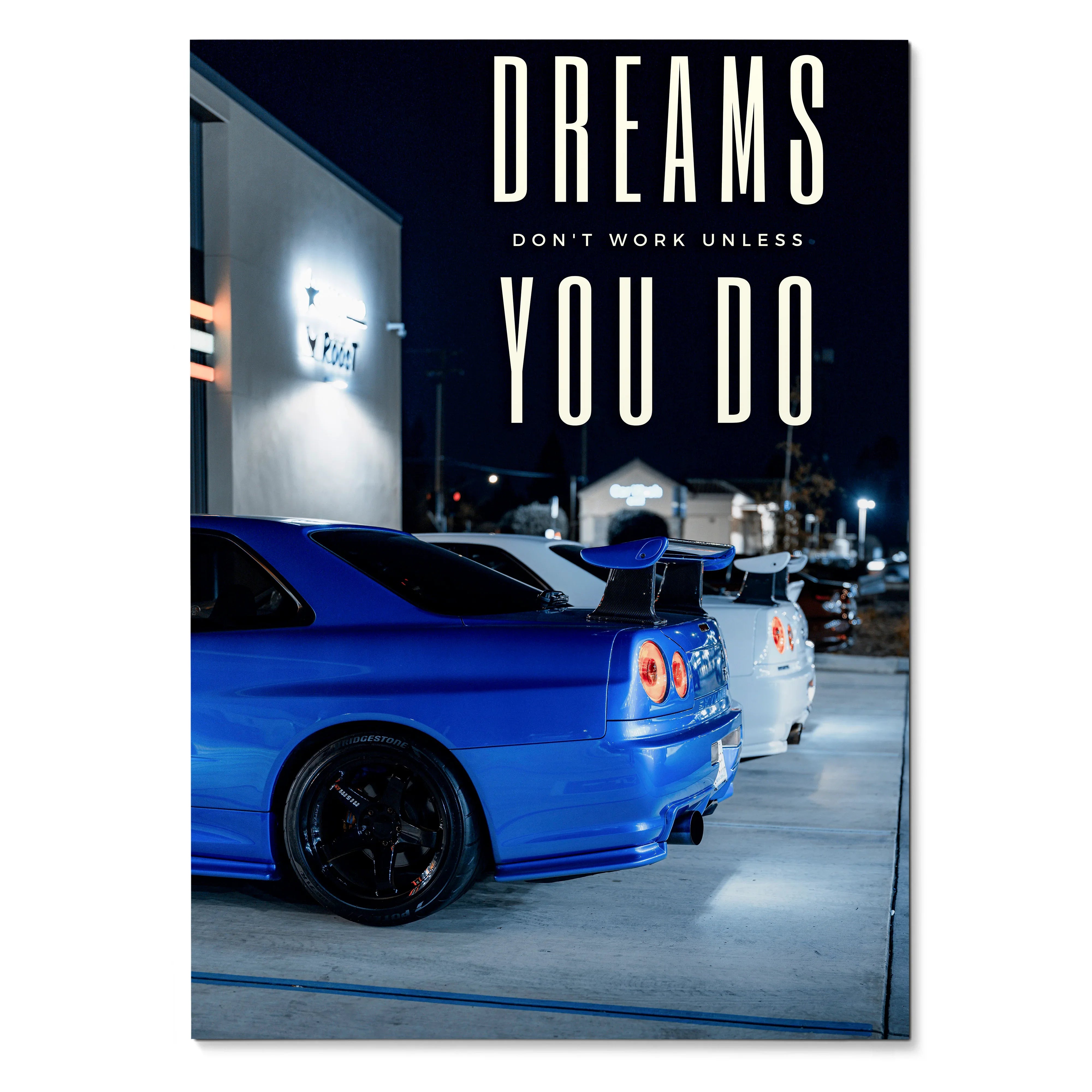 Motivational poster wall art featuring blue and white Nissan GT-R R34 Skyline cars at night with "Dreams Don't Work Unless.
