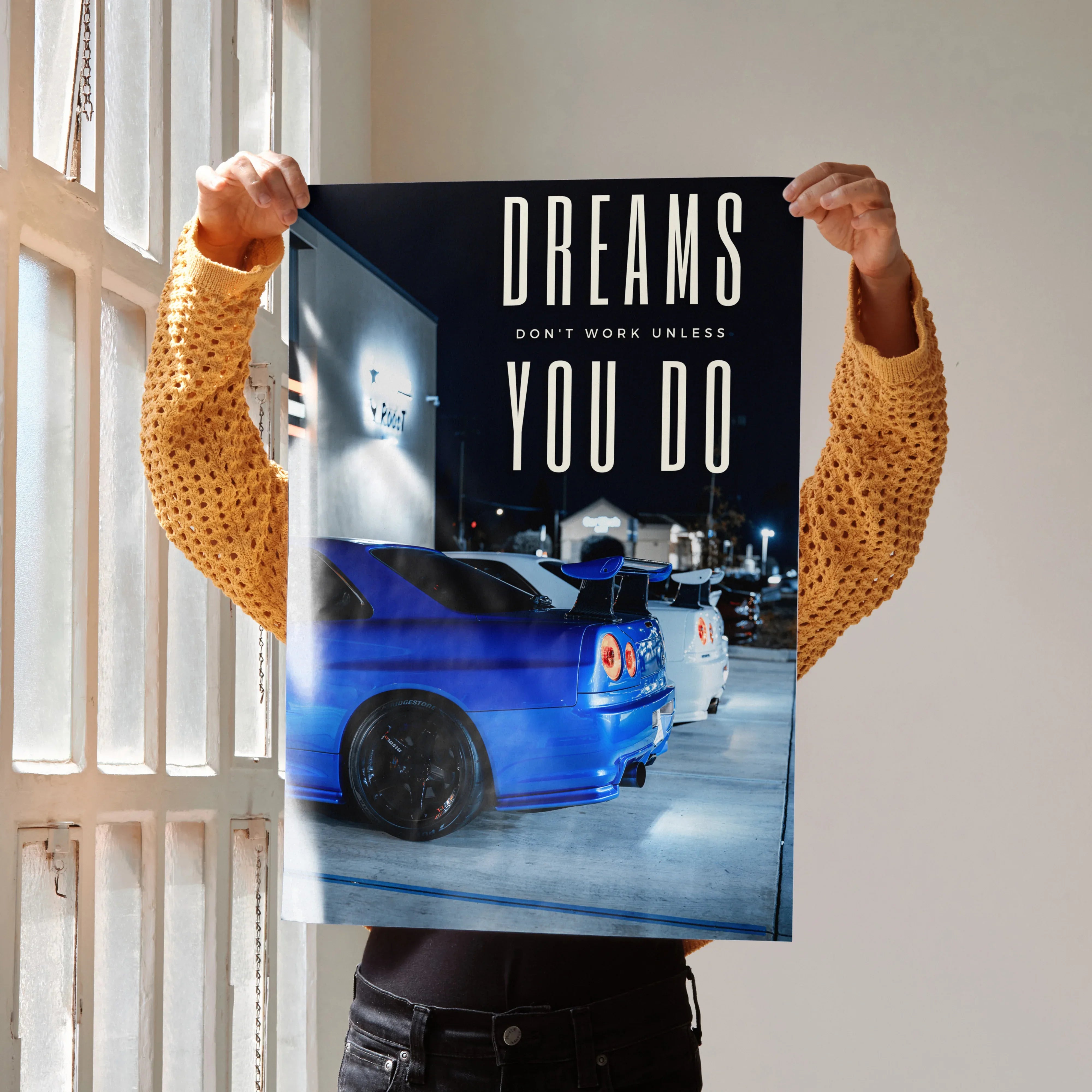 Motivational poster wall art featuring blue Nissan GT-R R34 Skyline under street lights with inspiring text.