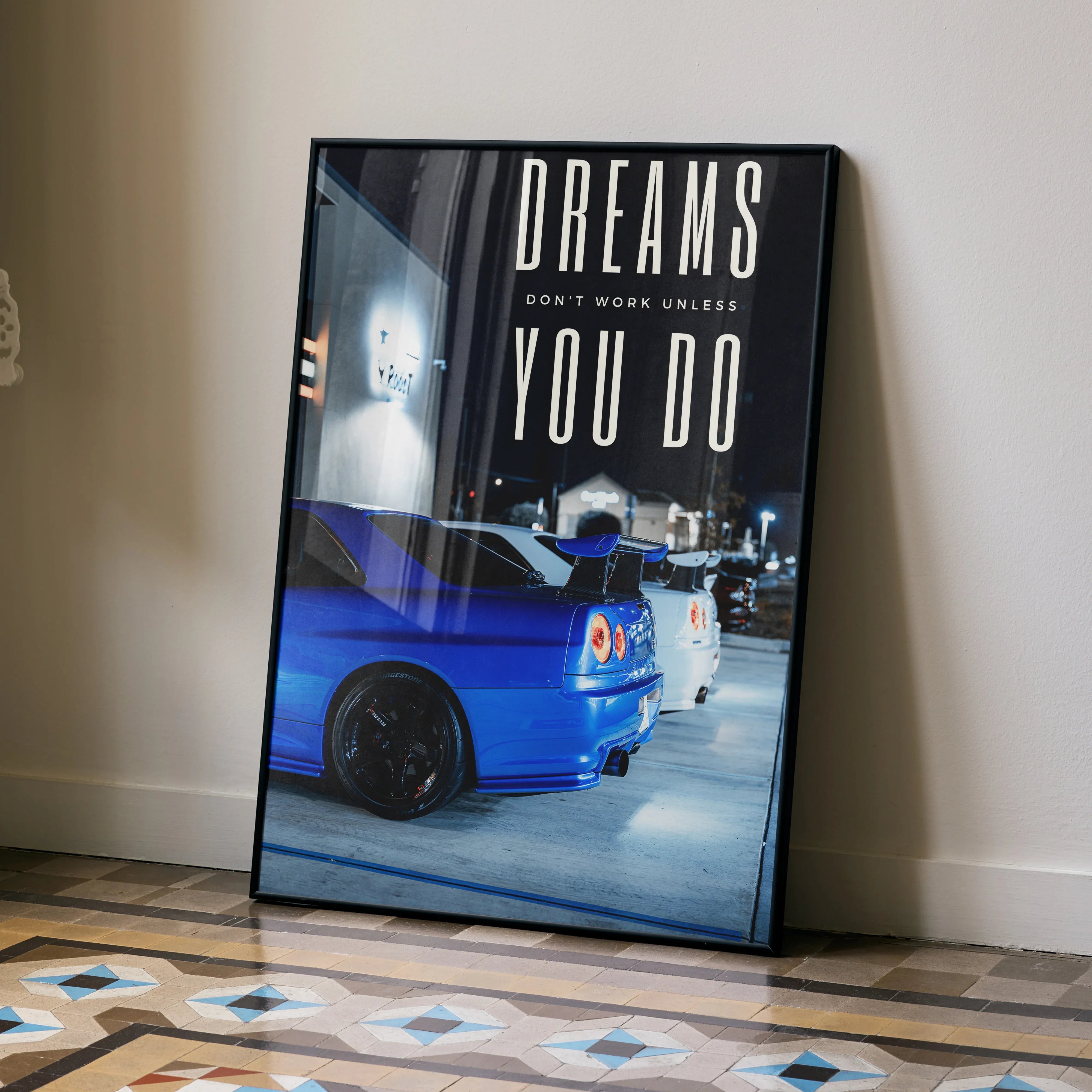Motivational poster wall art featuring blue Nissan GT-R R34 Skyline with bold text "Dreams don't work unless you do".