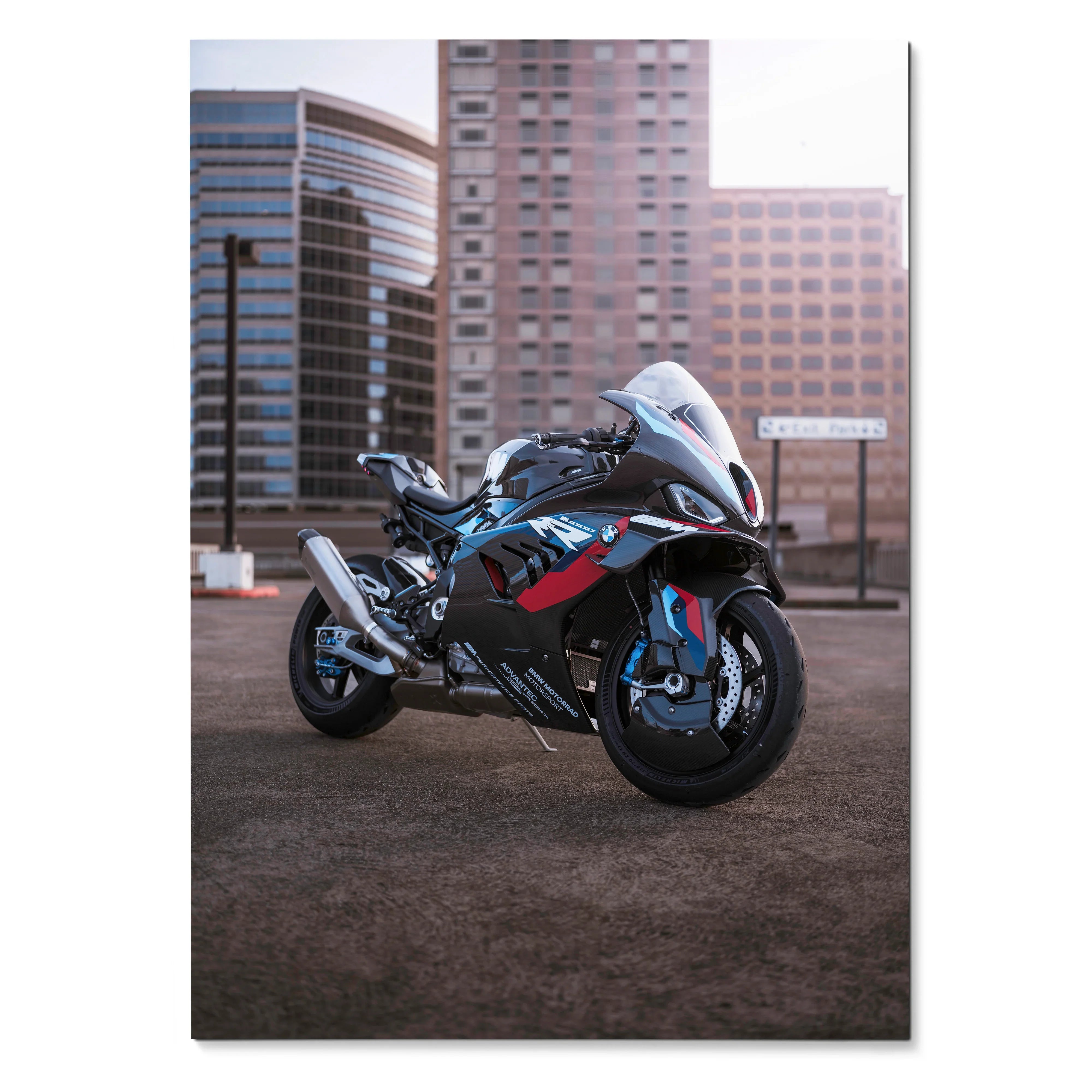 BMW M1000RR motorcycle poster wall art with sleek black and red sportbike design against urban backdrop.
