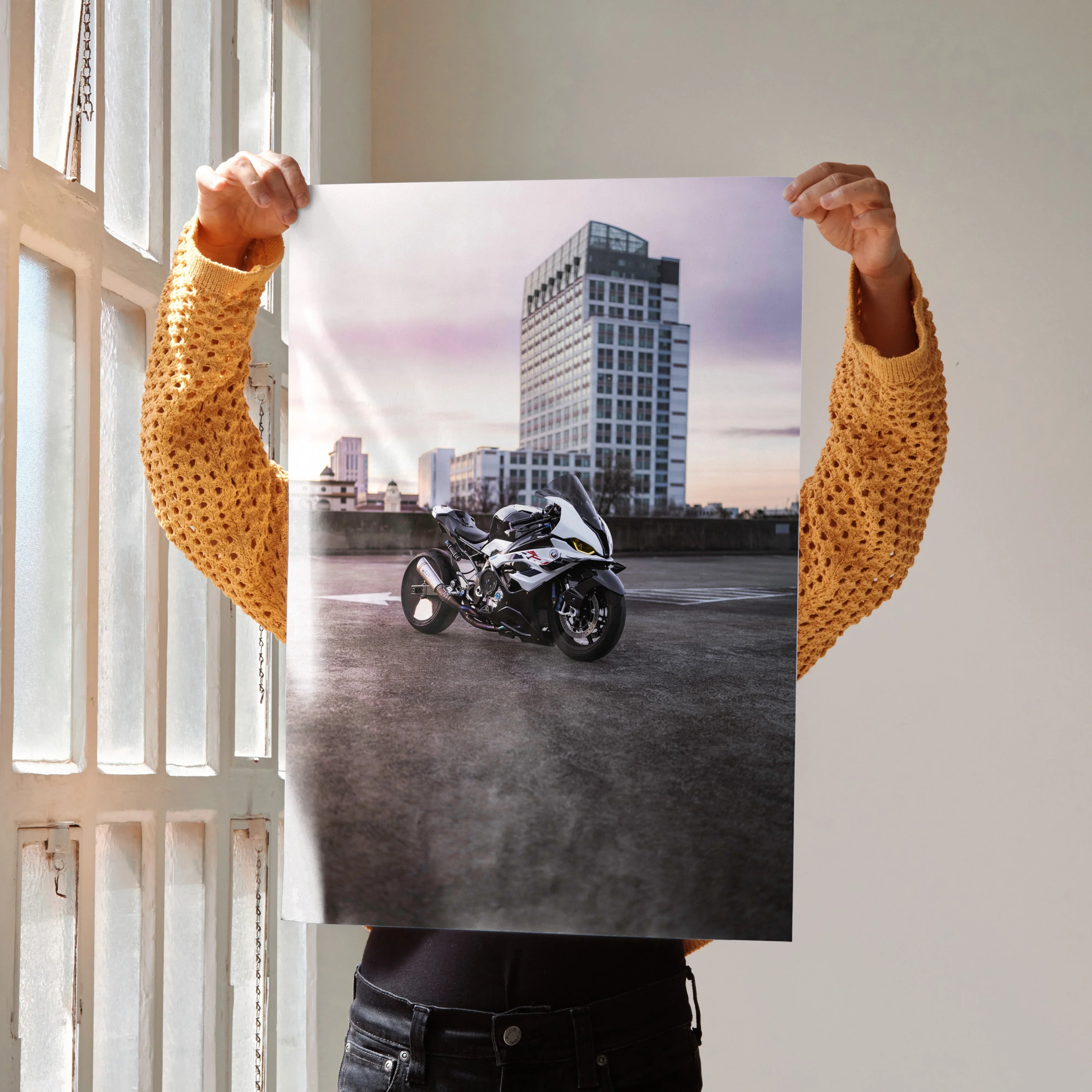 BMW S1000RR motorcycle poster as wall art with urban cityscape background.