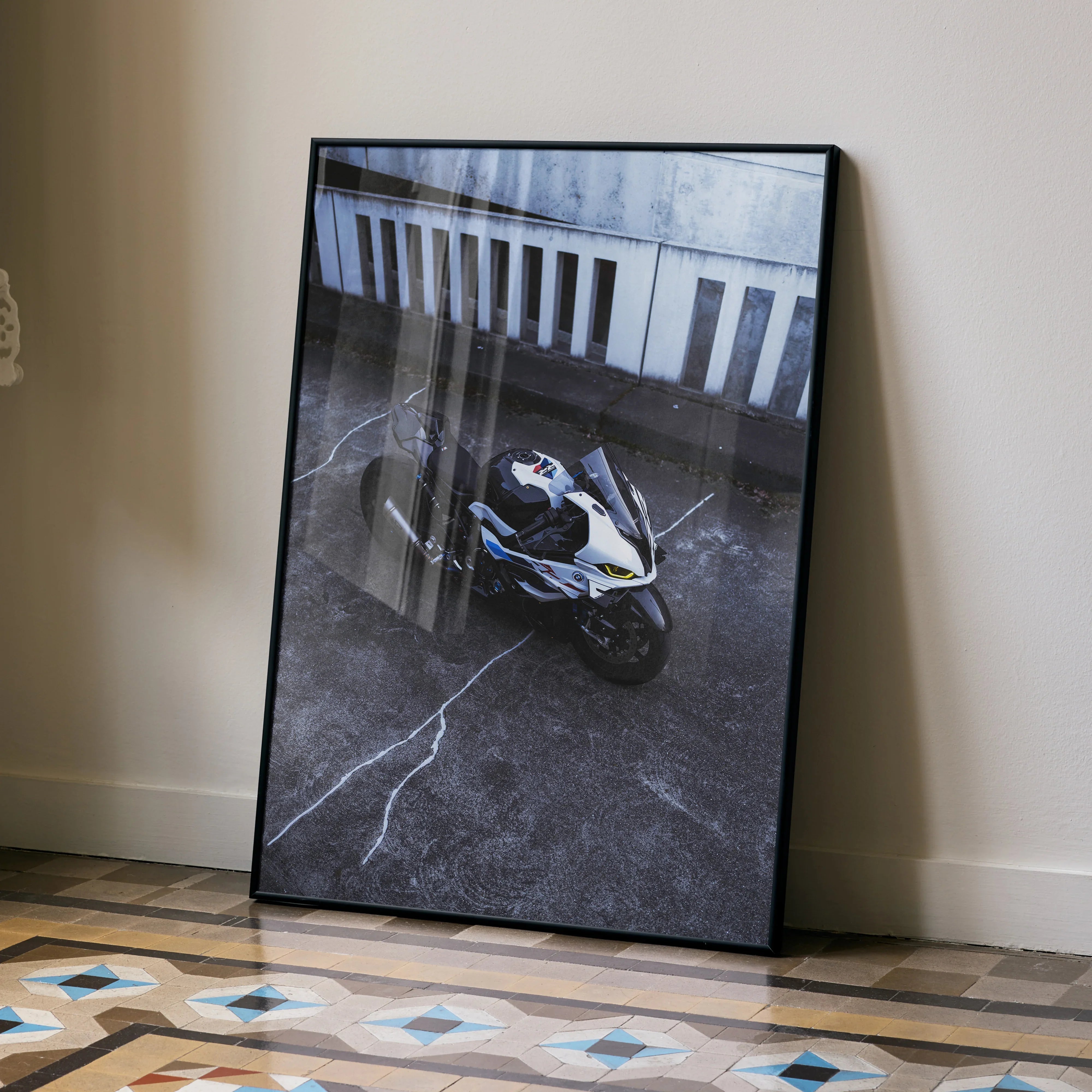 BMW S1000RR drag spec motorcycle poster leaning against wall, modern wall art with urban backdrop.