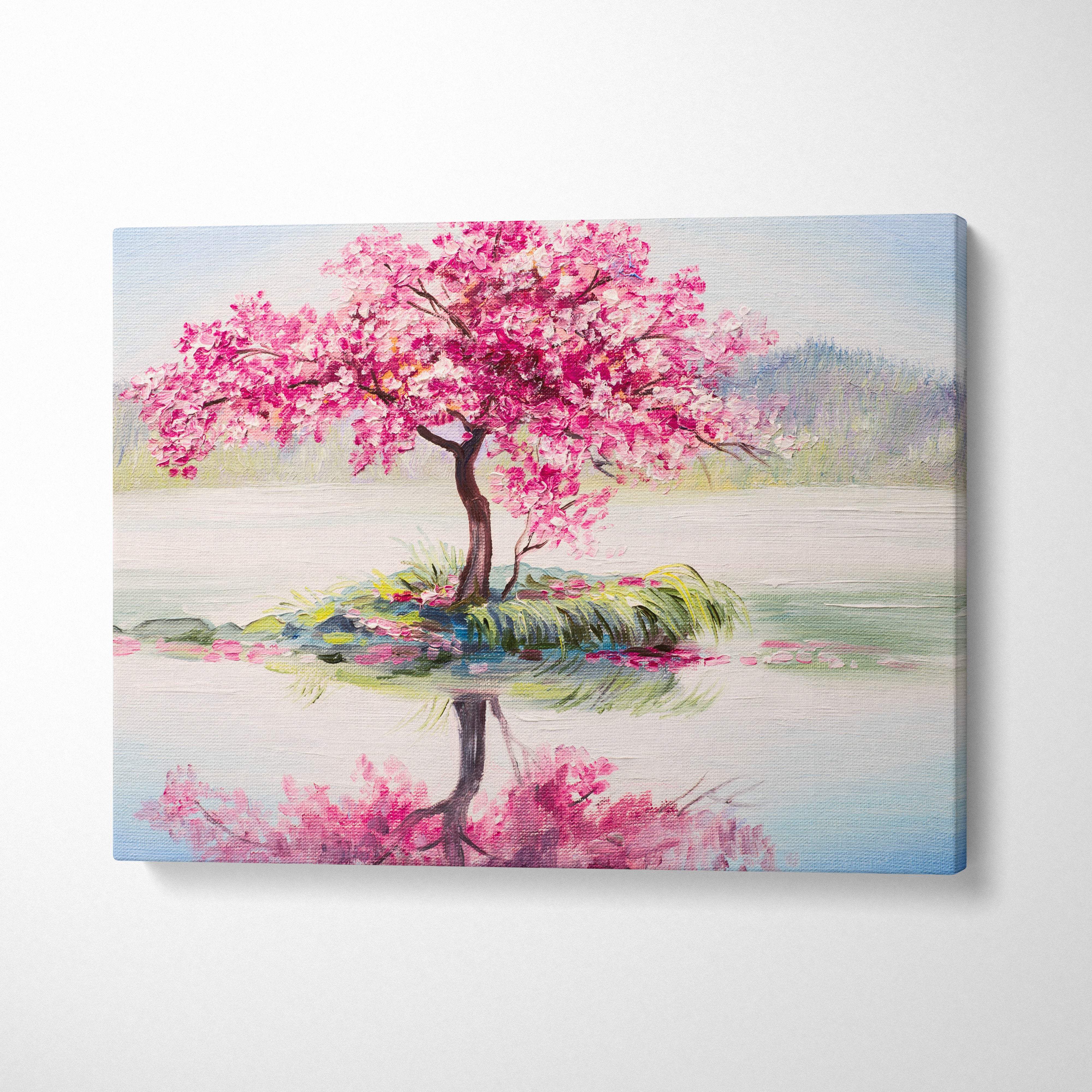 A vibrant pink cherry blossom tree painting on stretched canvas with bold brushstrokes and serene lake reflection