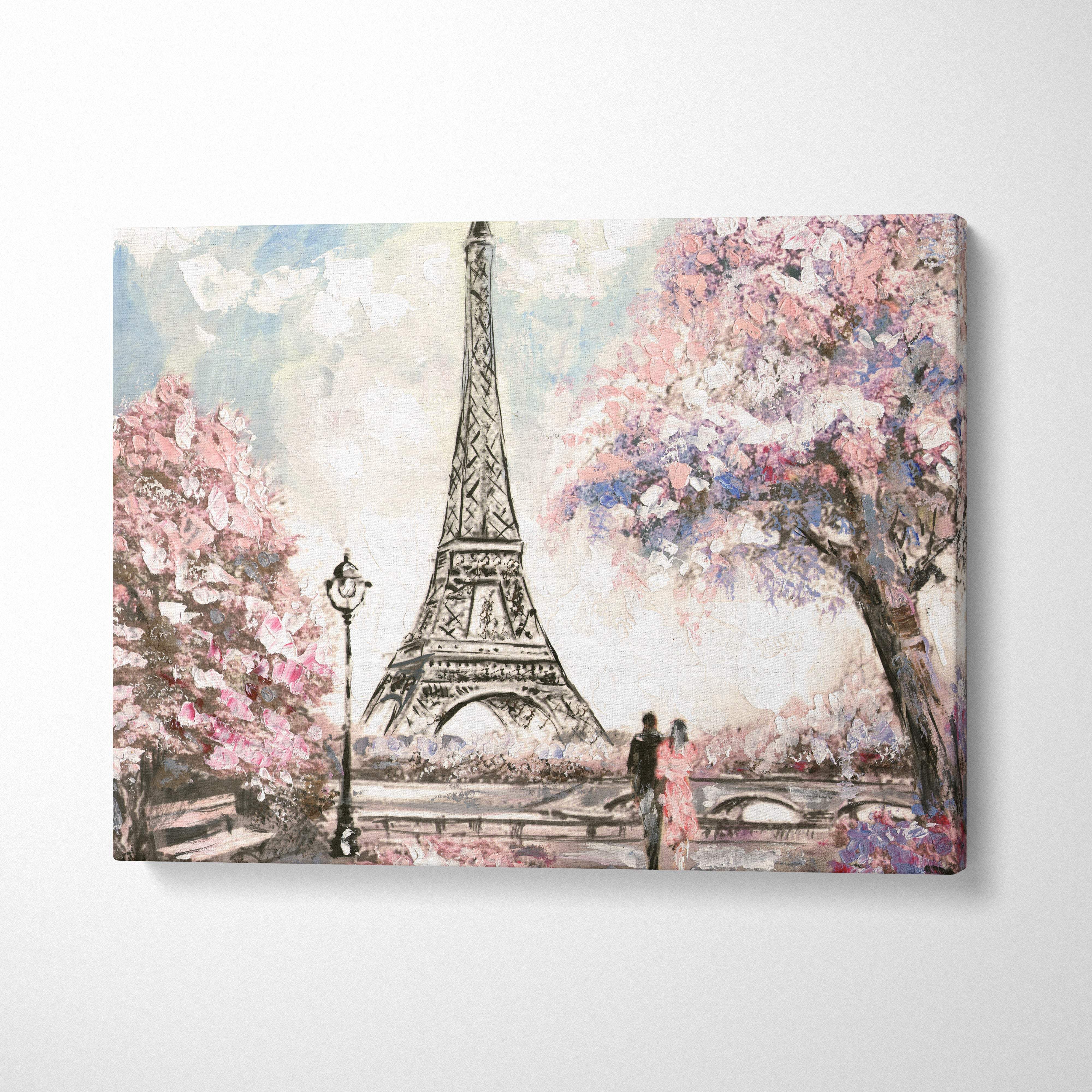 A soft pastel canvas print of the eiffel tower framed by pink cherry blossoms with a romantic couple stroll