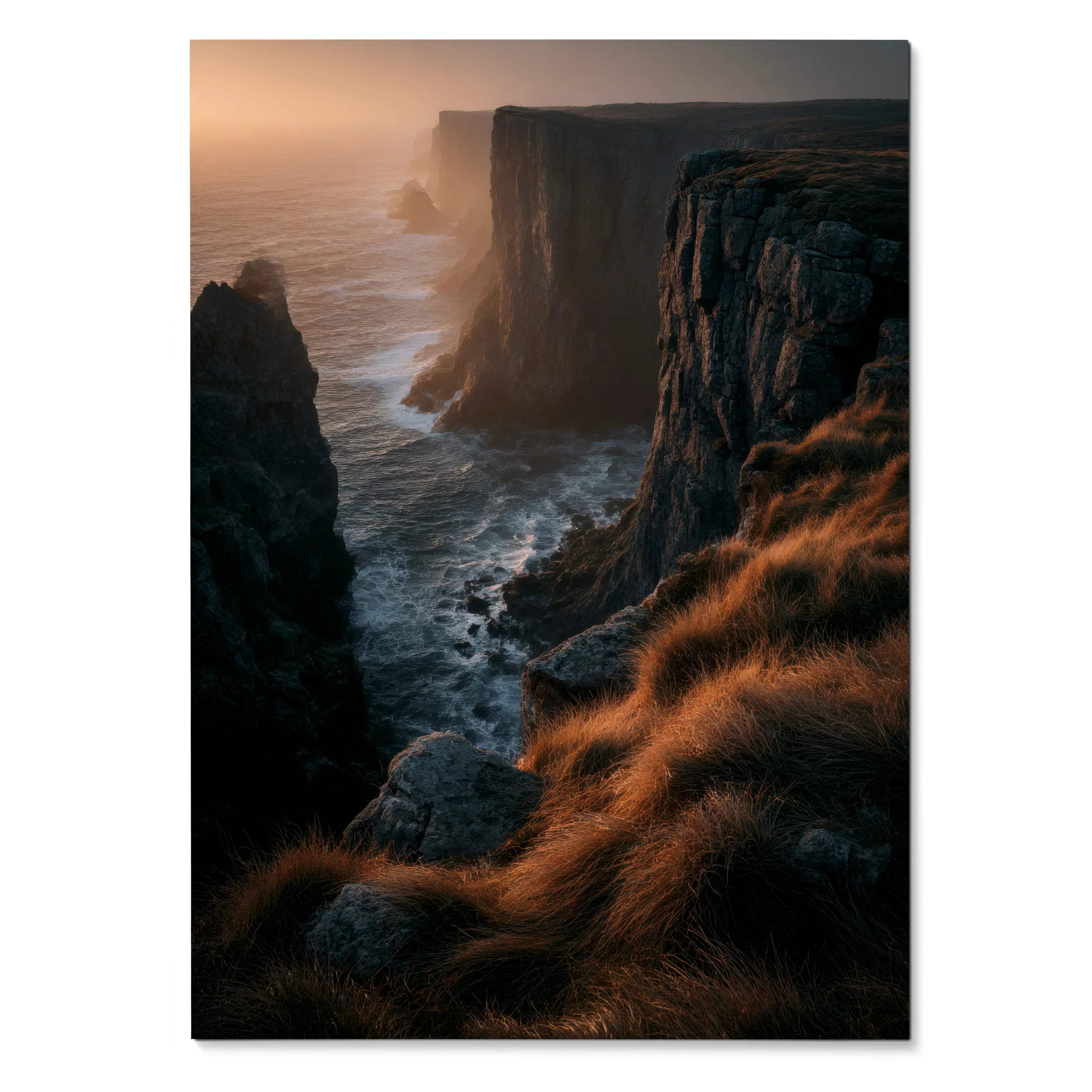 Sunset over rugged cliffside with golden grass, ocean waves, vertical nature art poster.