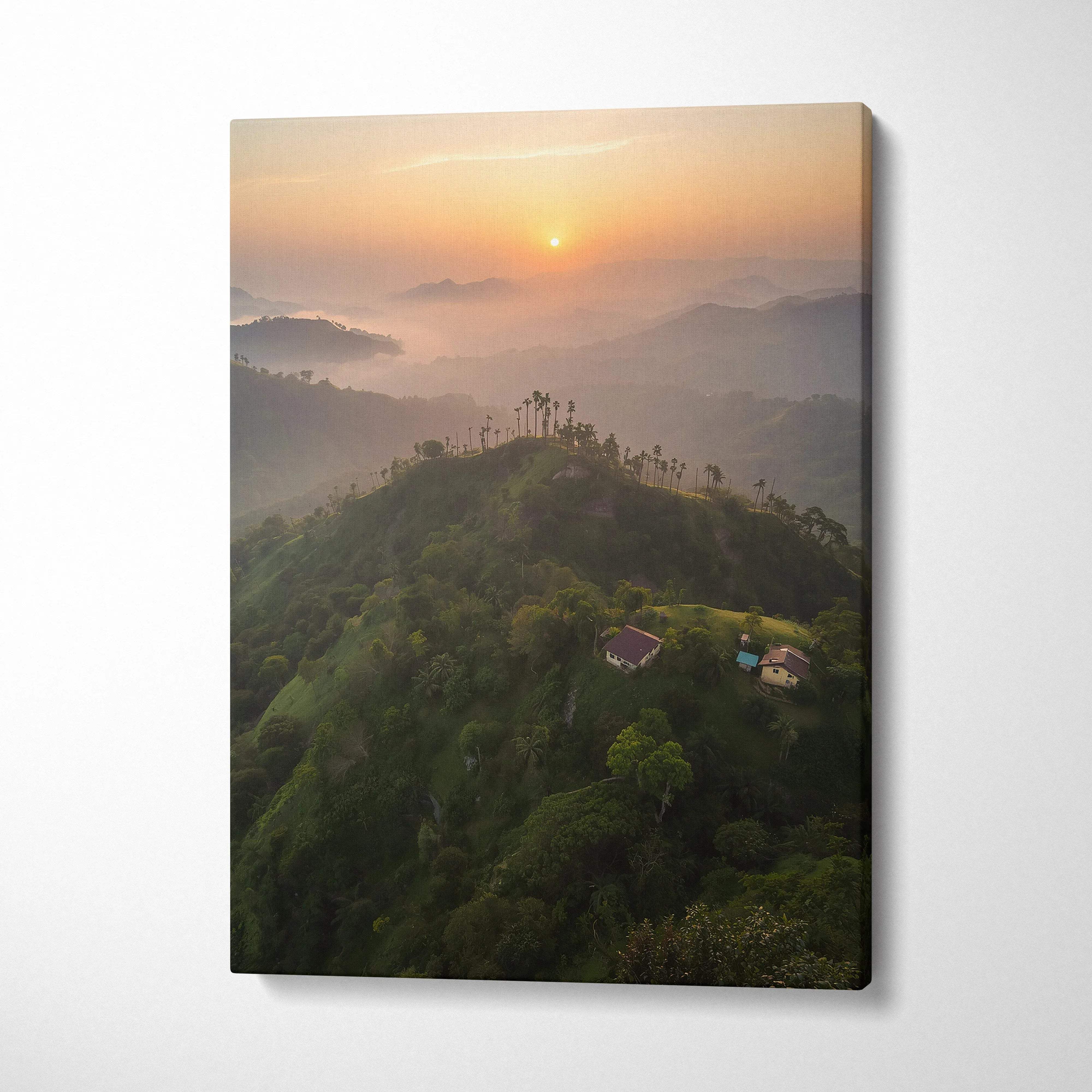 Canvas wall art featuring a misty mountain landscape at sunset with soft orange sky.