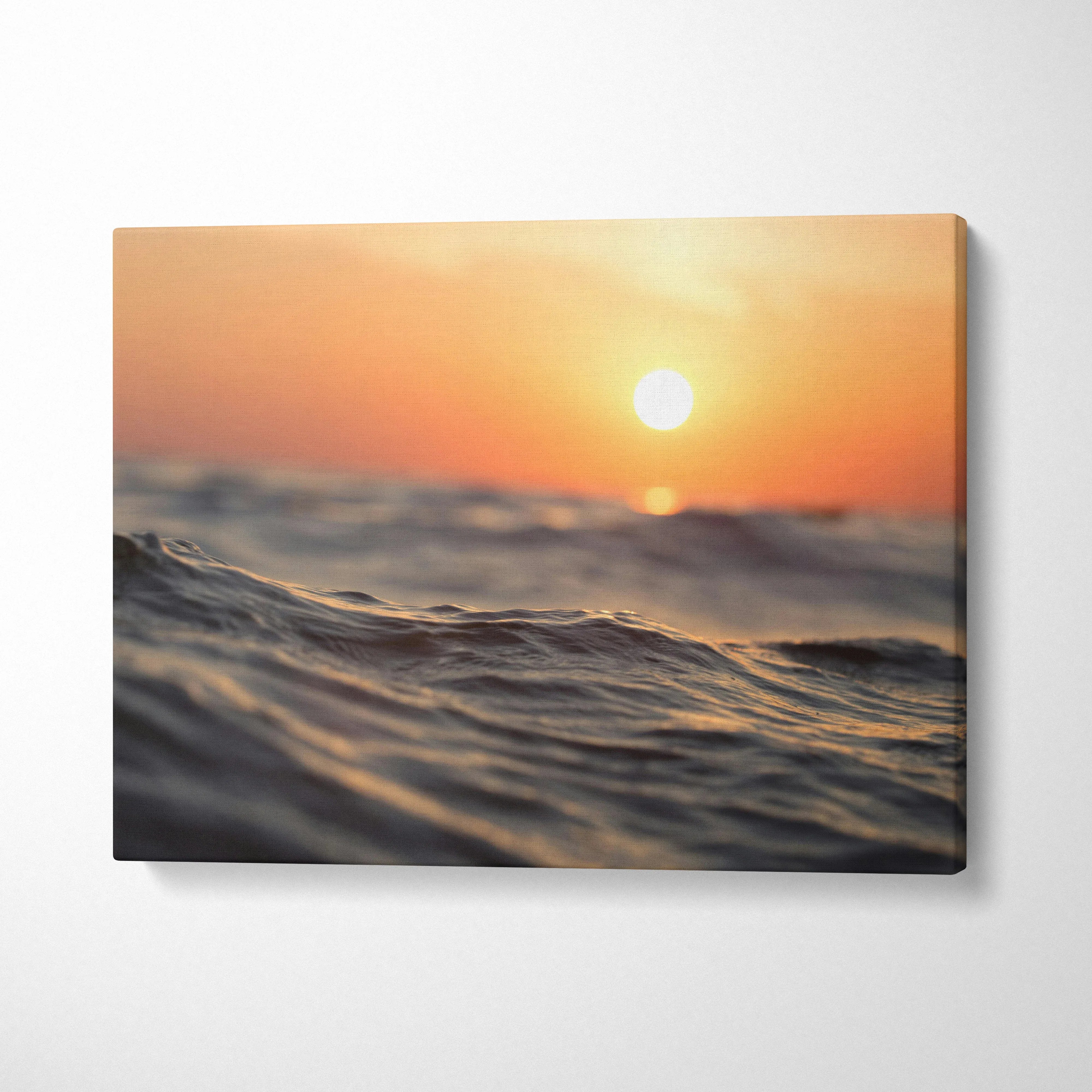 Sunset over ocean waves digital art printed on canvas wall art with warm orange tones.