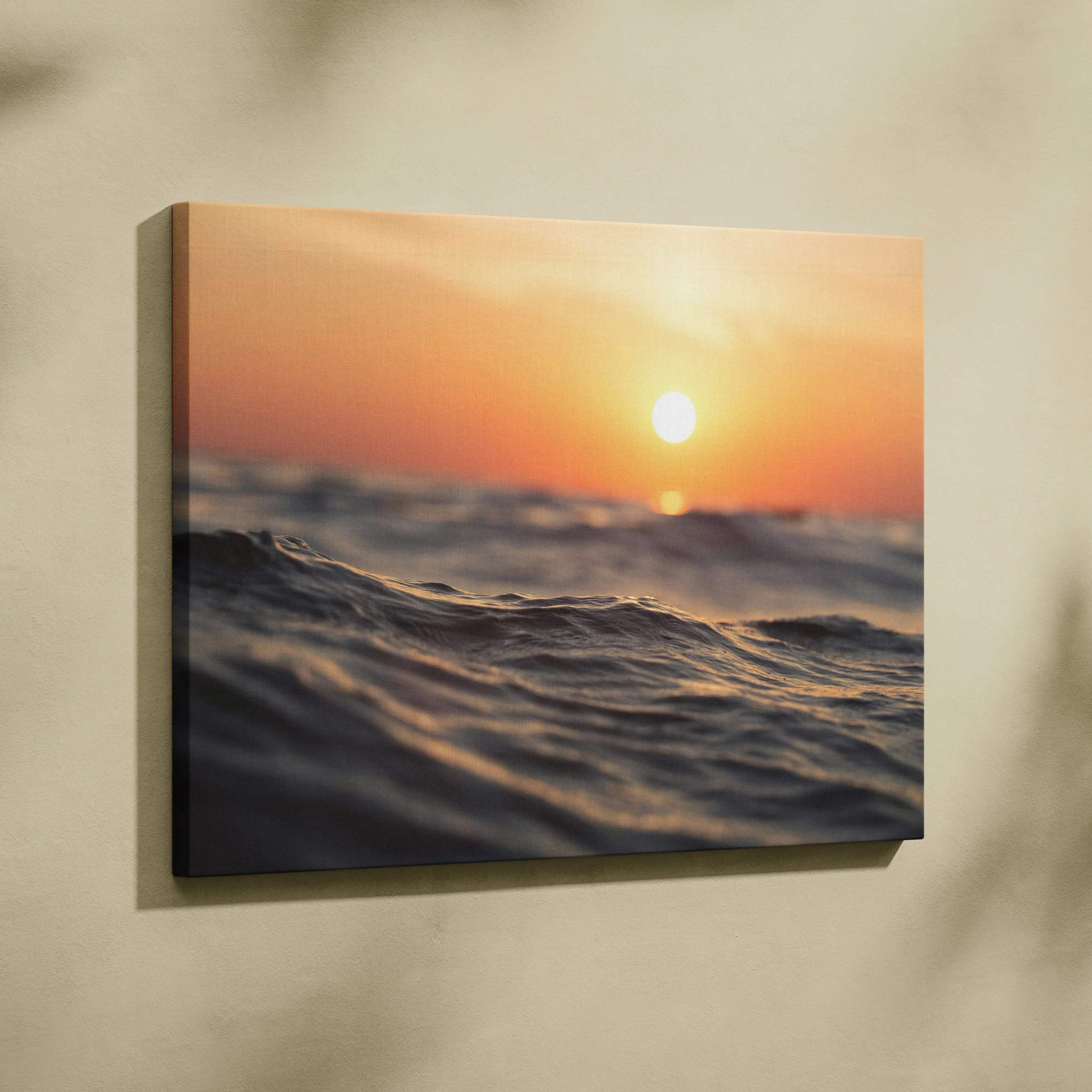 A rectangular canvas print featuring a vibrant sunset over ocean waves with warm orange pink and blue hues