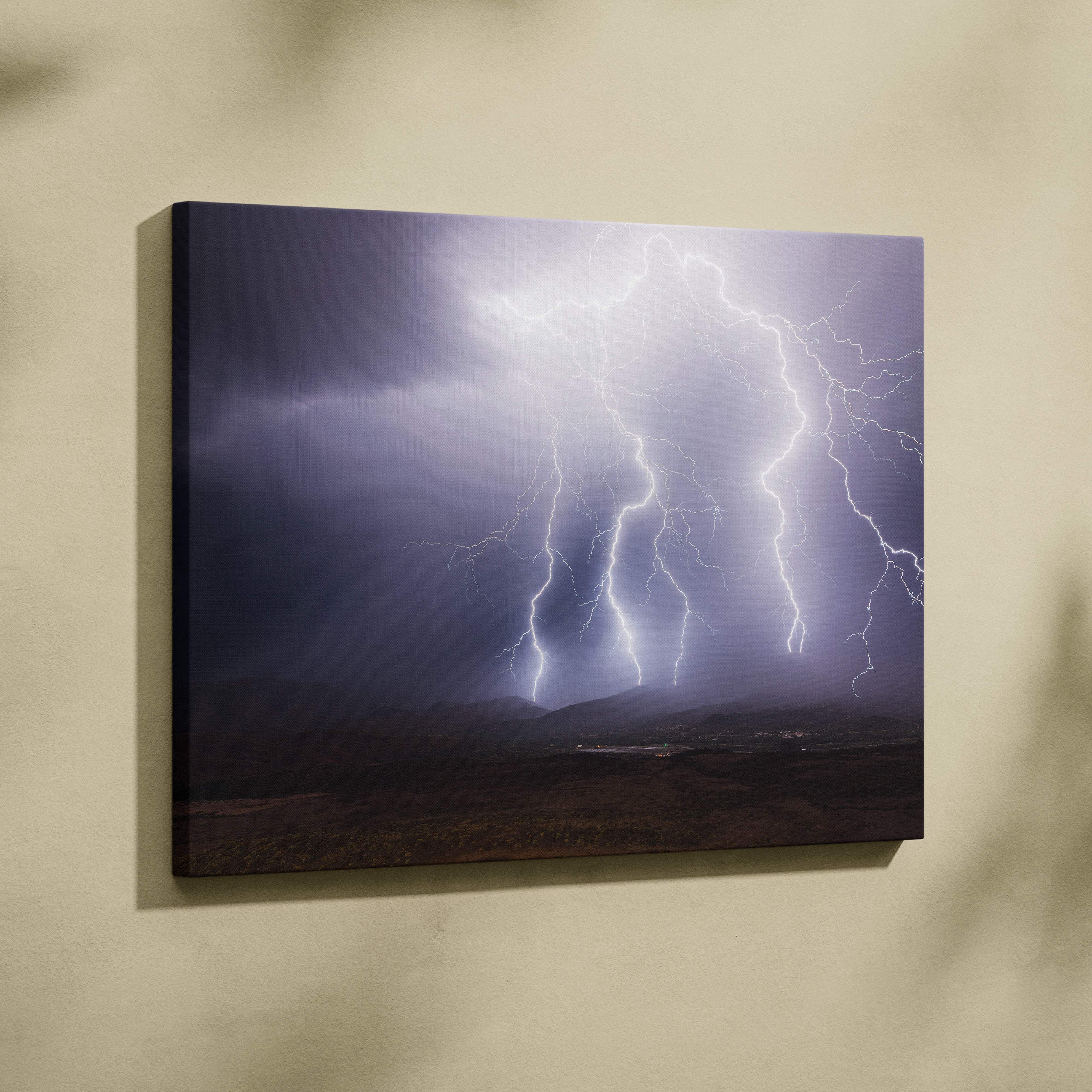 Canvas print of multiple vivid white and purple lightning bolts striking dramatic dark clouds over mountain landscape wall decor