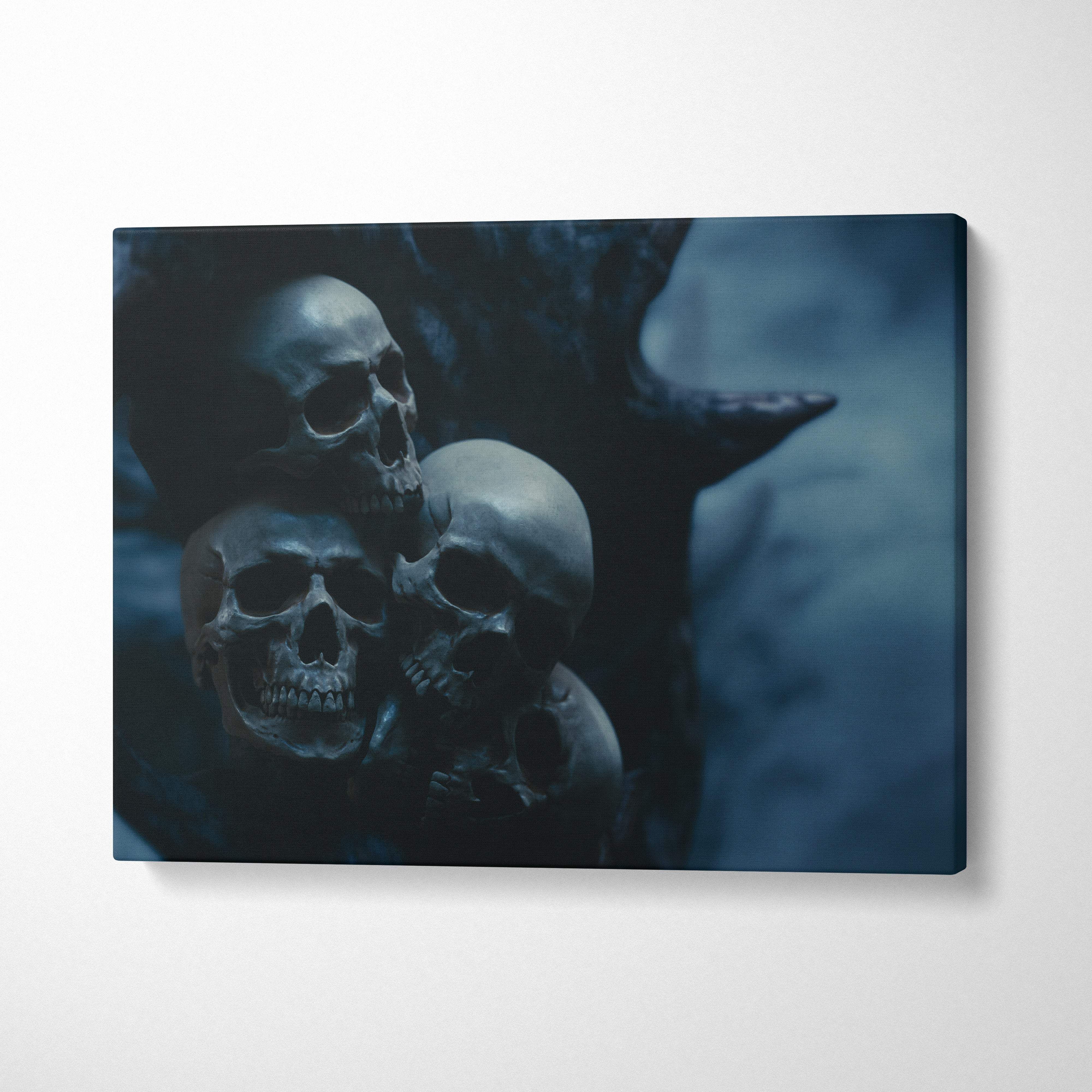 Dark blue canvas wall art print featuring three detailed human skulls for gothic halloween or moody bedroom decor