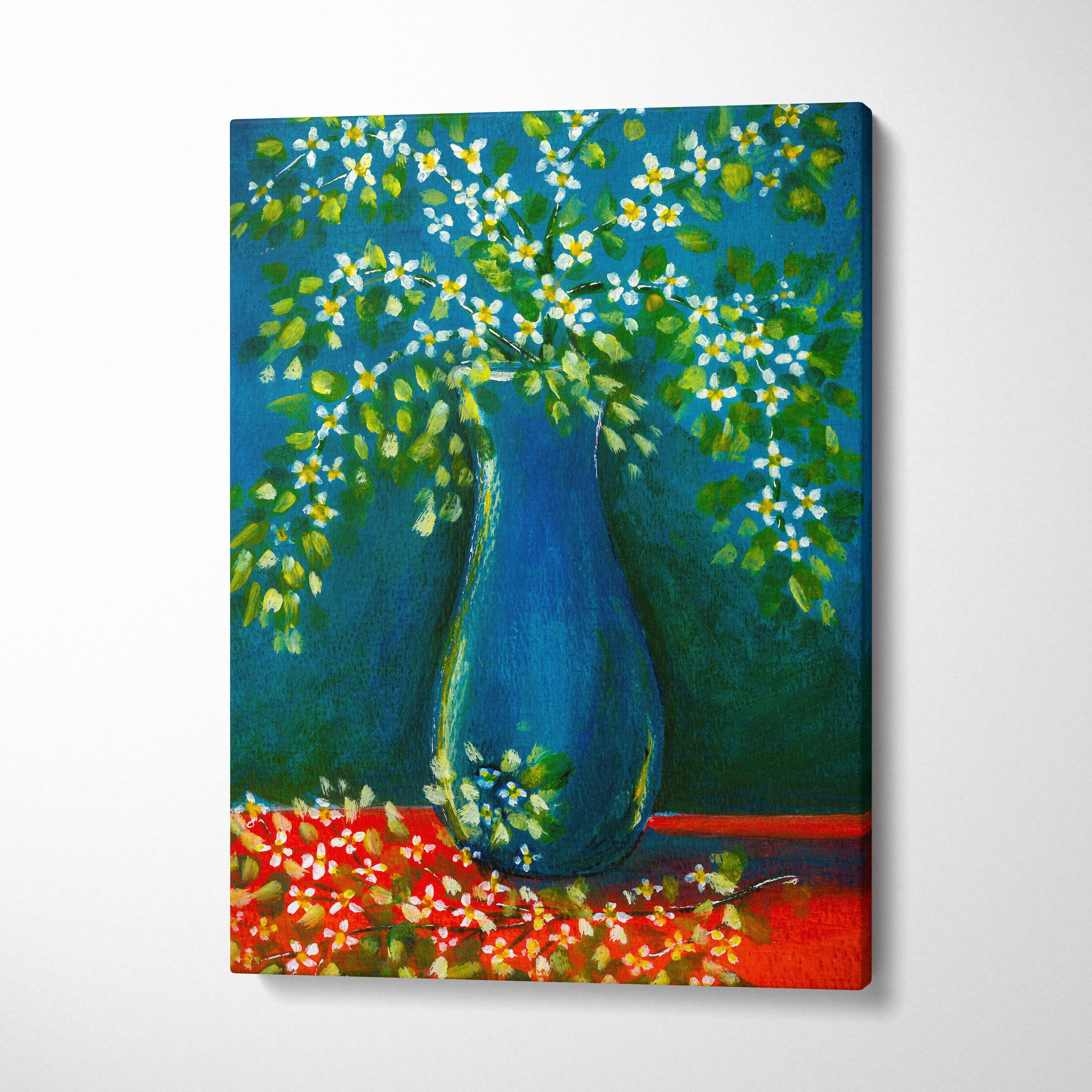 A vibrant blue ceramic vase filled with white and yellow blossoms on a blue vase floral canvas print wall art