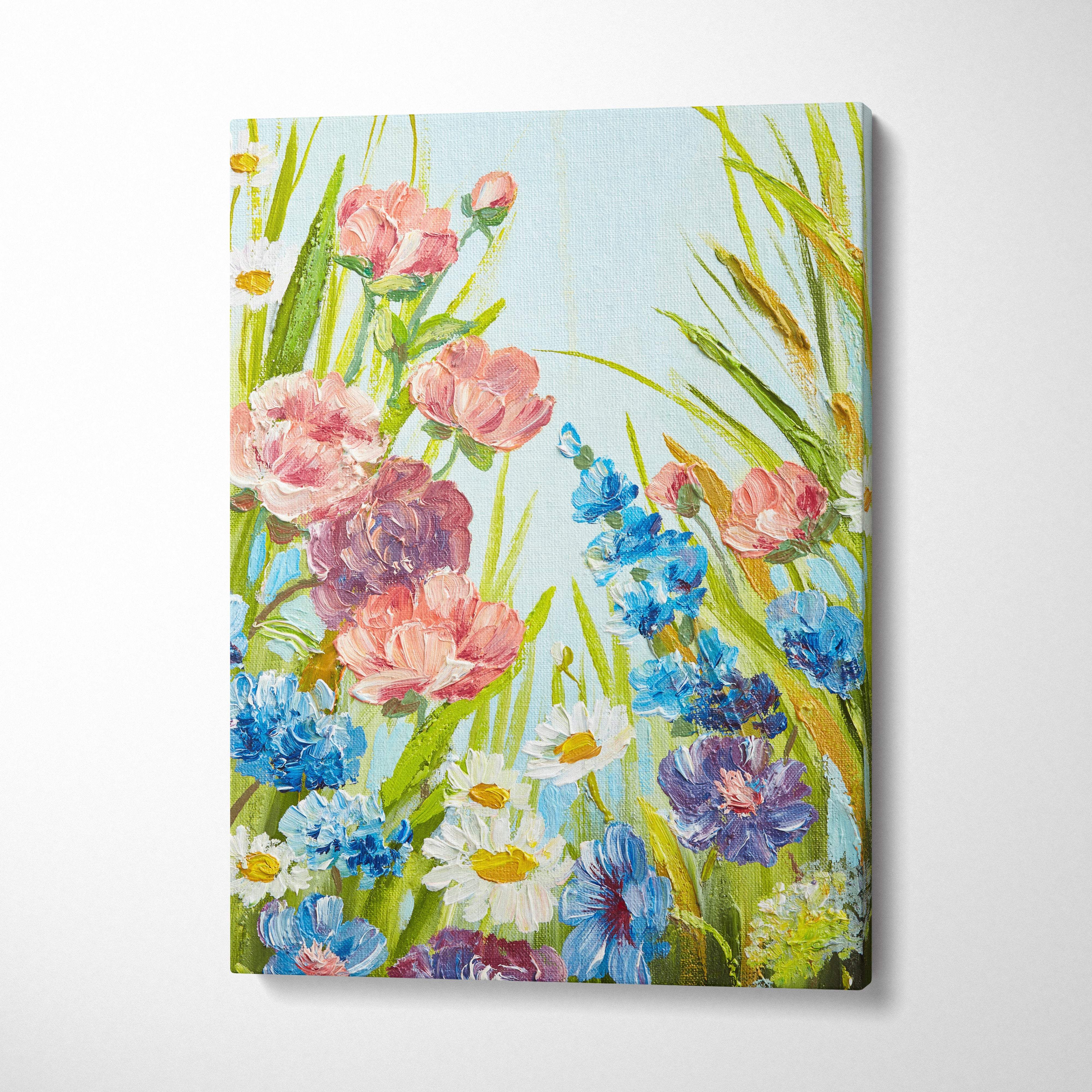 Vibrant canvas wall art featuring a lush pink blue and purple wildflower meadow with green grass and light sky background