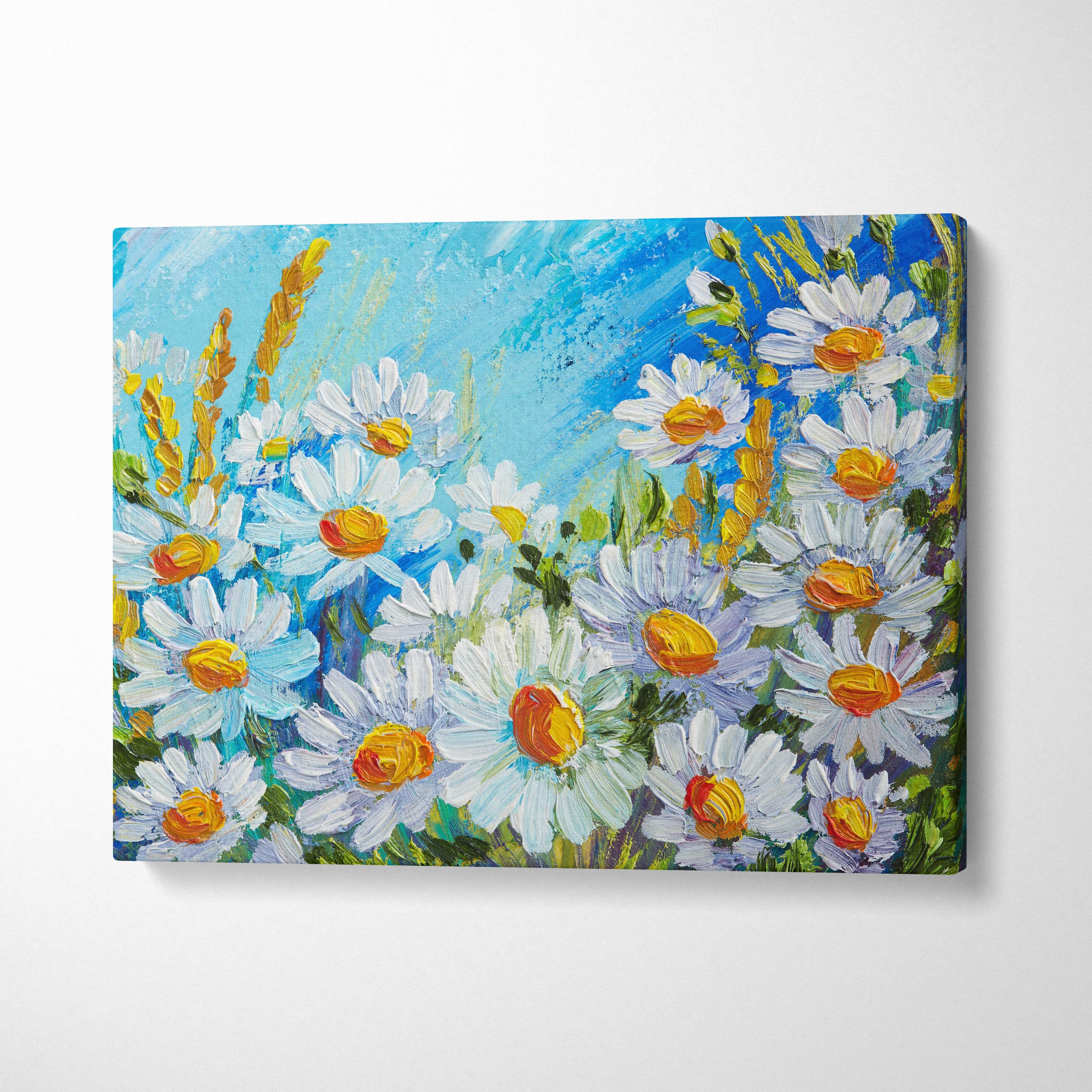 Vibrant canvas wall art print of white daisies with yellow centers and golden wheat against textured blue sky for chic french interiors