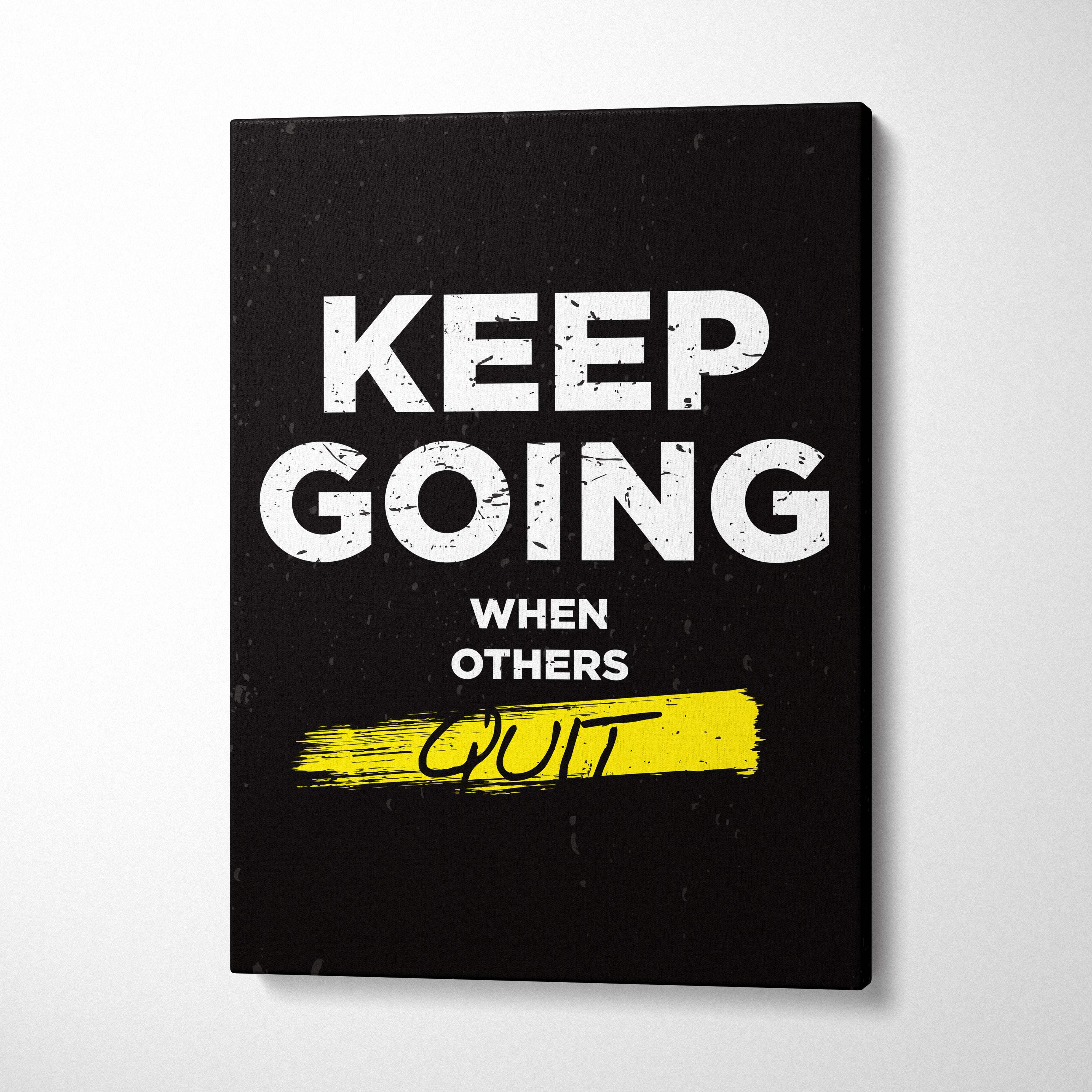 Black canvas print featuring keep going when others quit motivational phrase with yellow brushstroke accent for gym or office decor