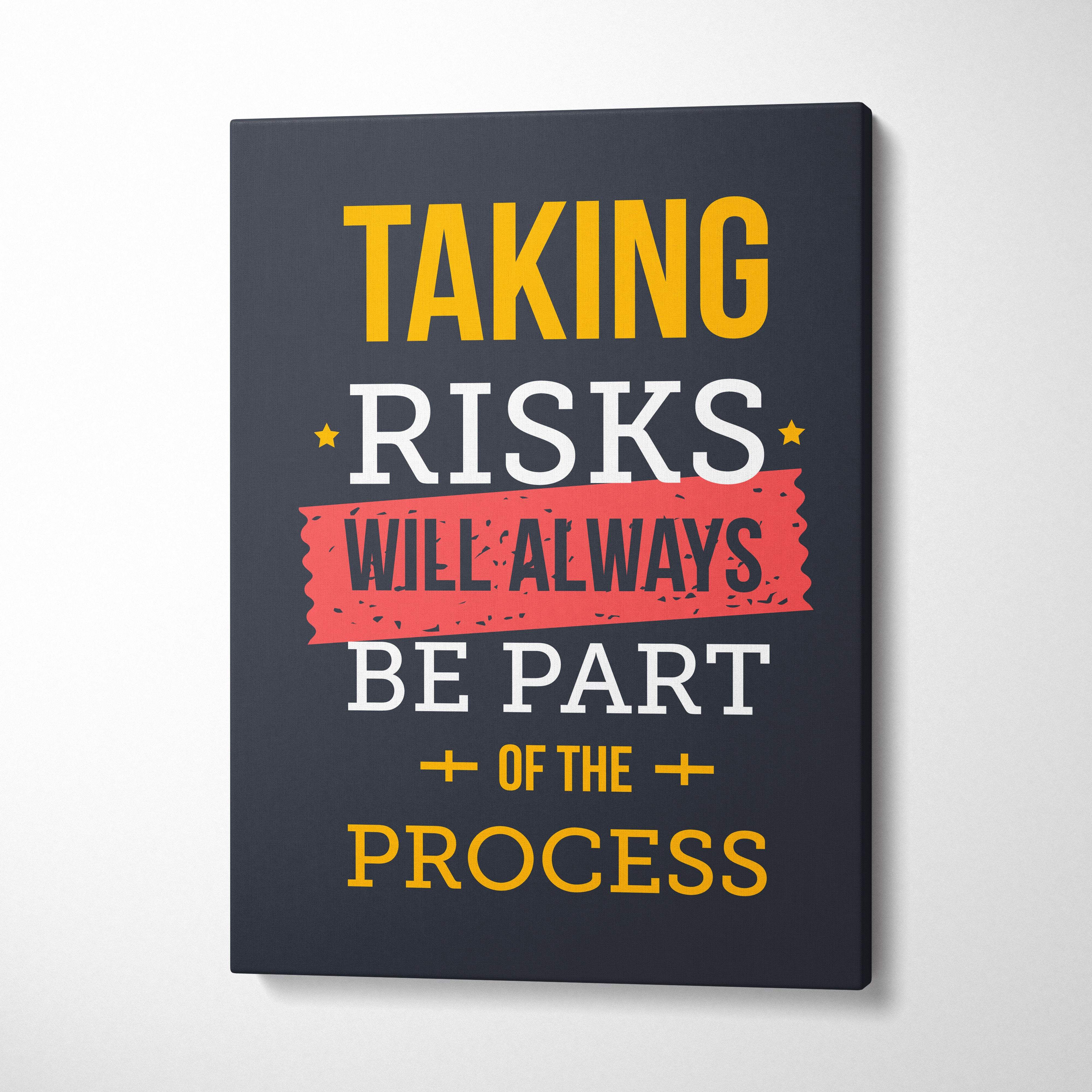 Black canvas print with bold yellow white text and red banner featuring taking risks will always be part of the process motivational phrase