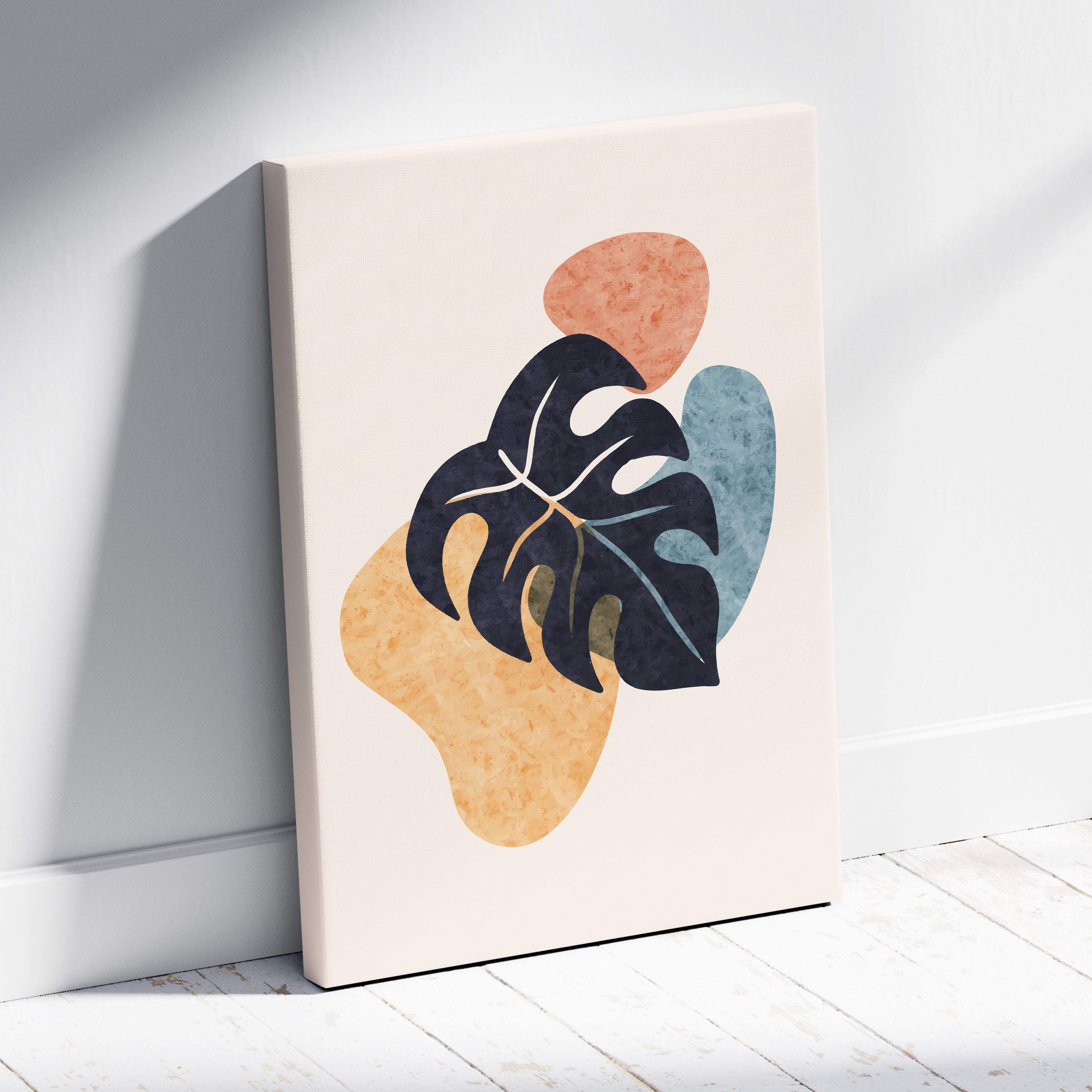 A modern abstract canvas print featuring a bold black monstera leaf on beige terracotta and muted blue shapes