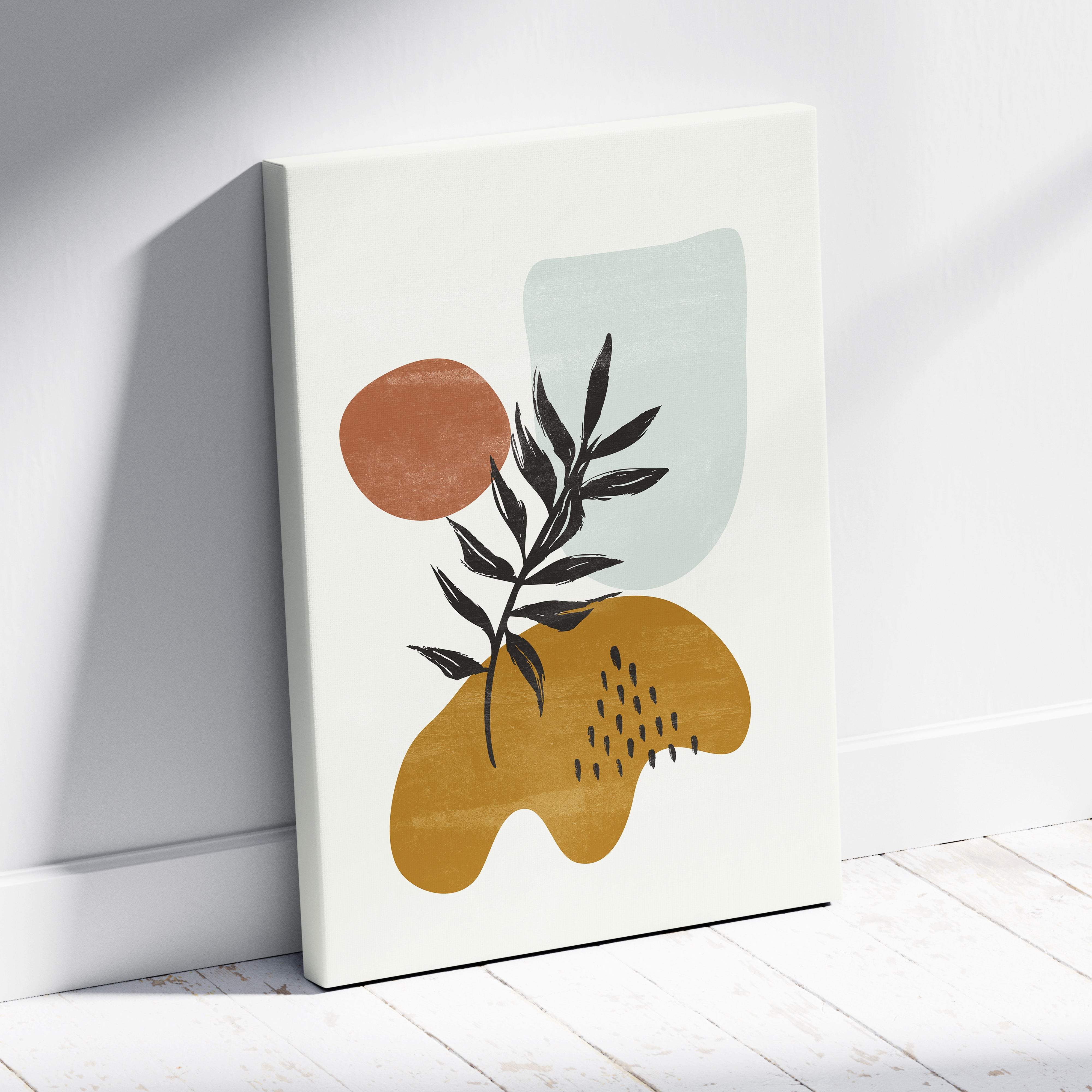 A modern abstract botanical wall art canvas print with a black leaf branch and earth tone terracotta mustard and sage green shapes
