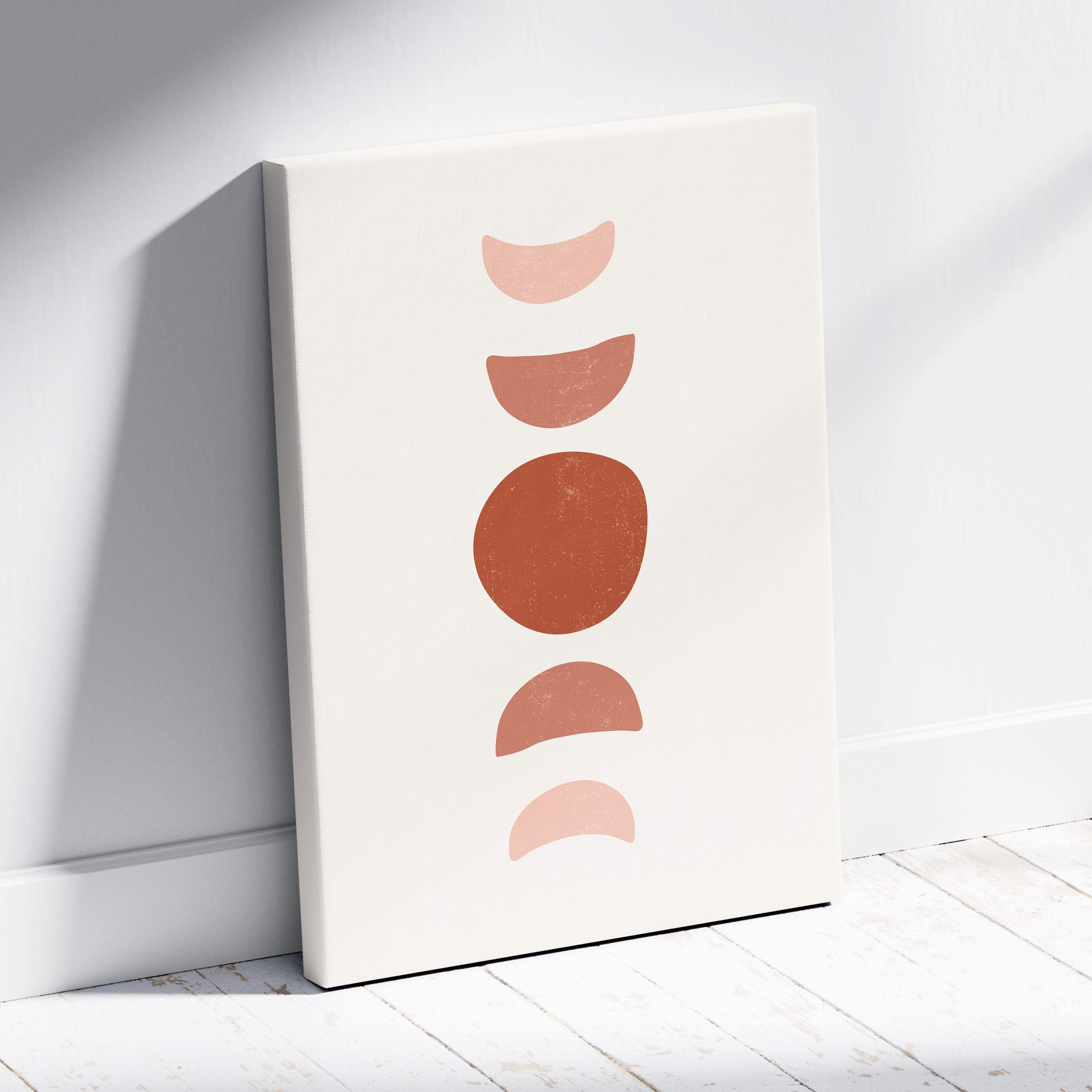 Cream-colored canvas print with minimalist earth-toned moon phases in terracotta and blush for boho wall decor