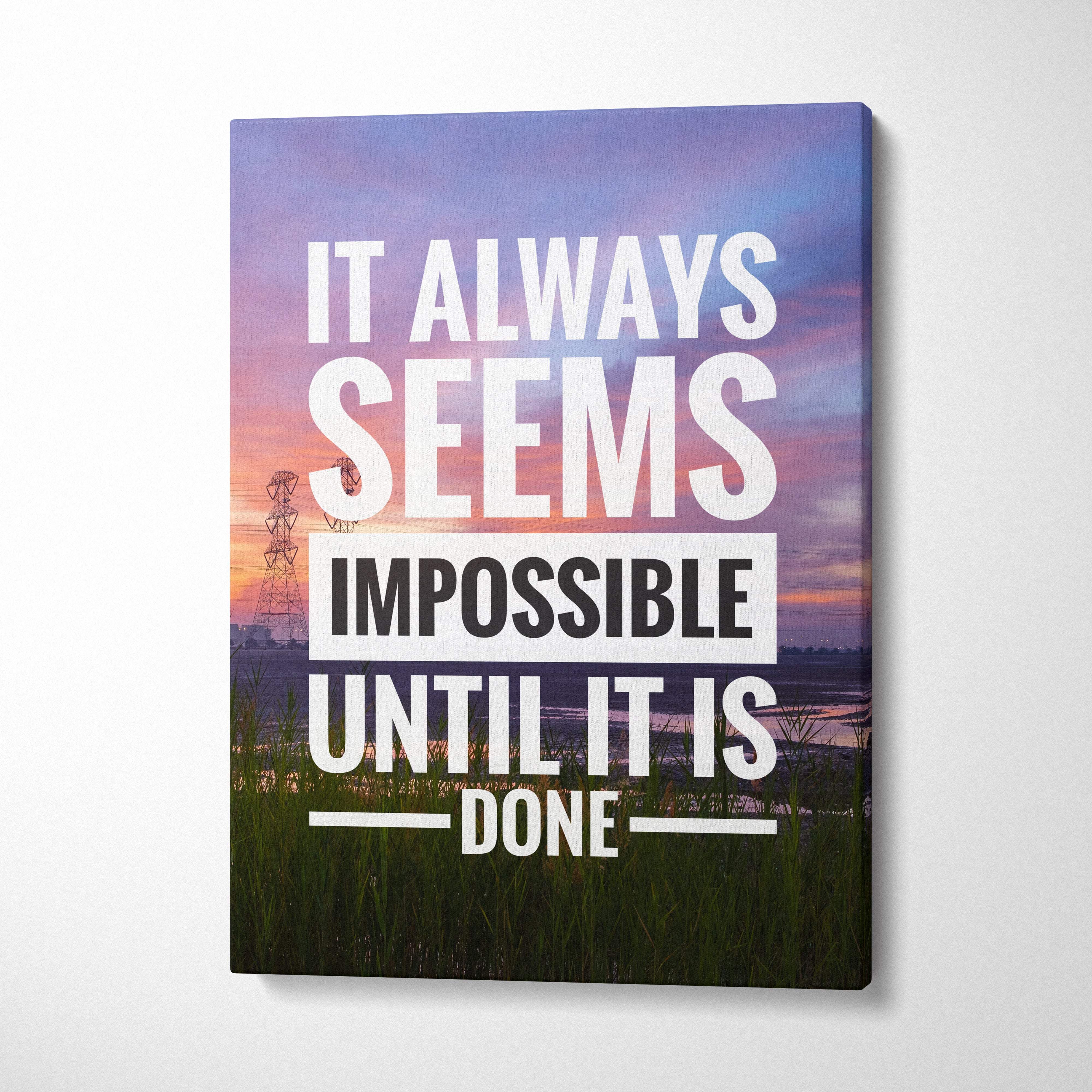 A rectangular canvas print with a motivational quote in white and black over a sunset landscape with grass and an electrical tower