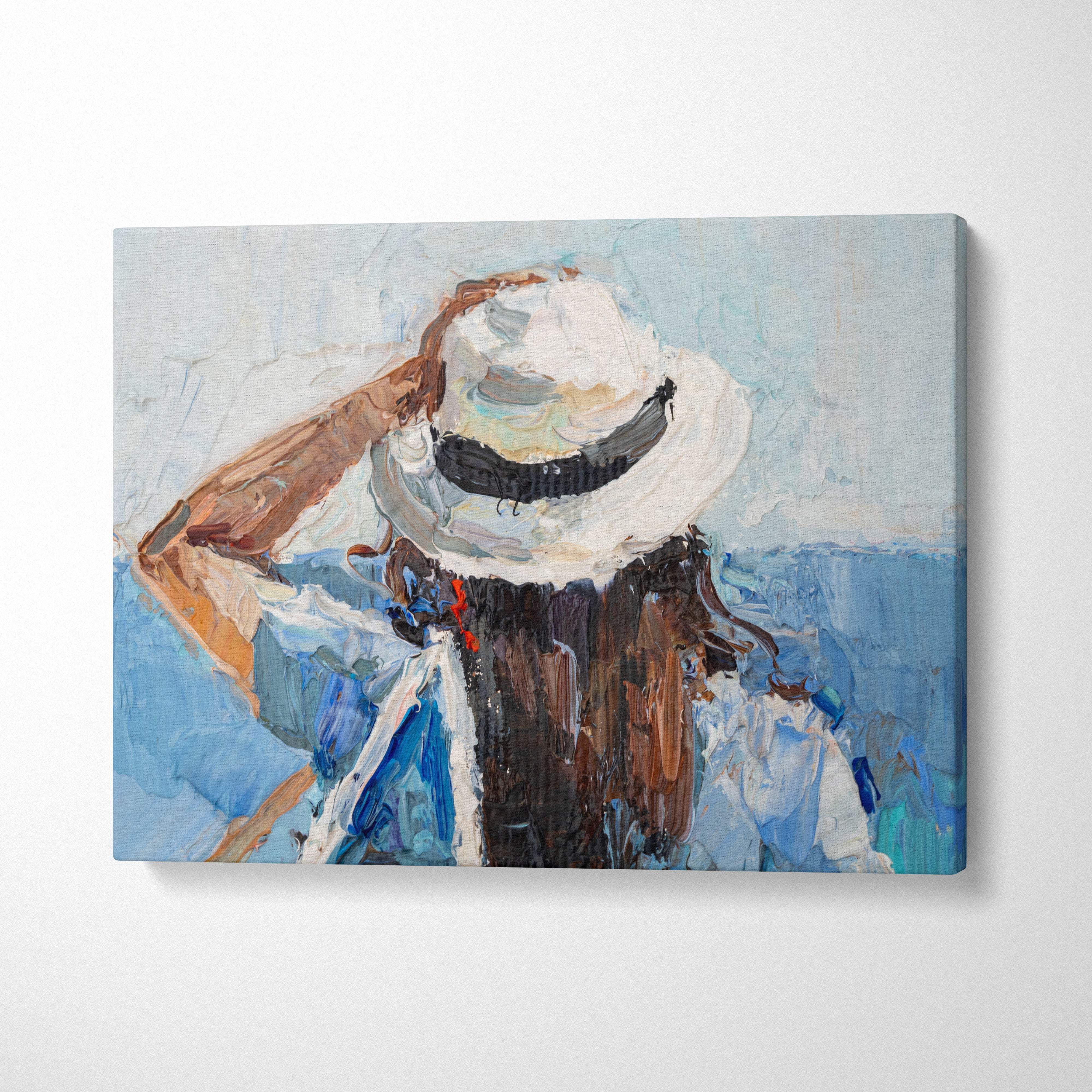 Textured canvas wall art print of a woman wearing a white straw hat with black band on a soft blue background