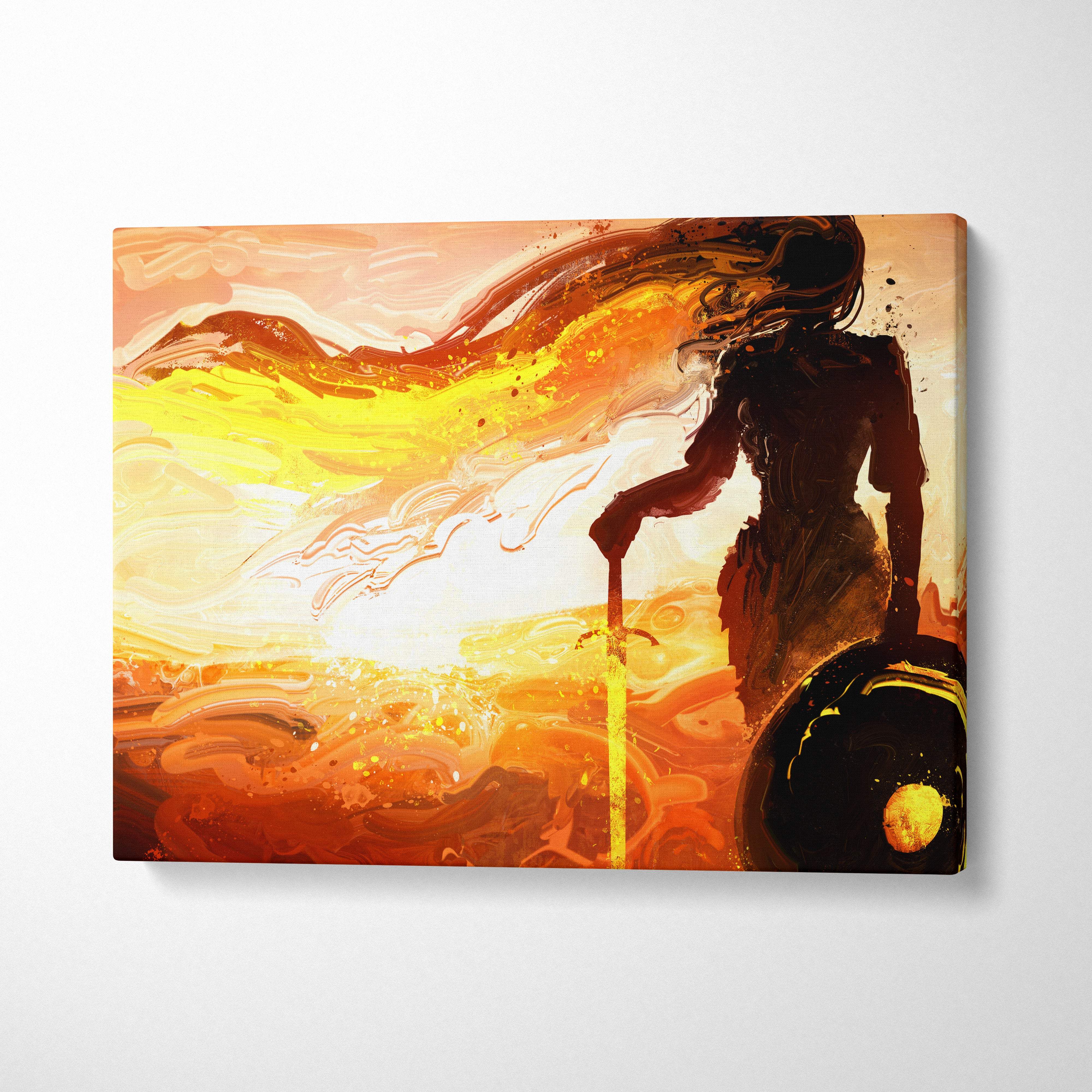 A canvas print of an abstract warrior woman silhouette with sword and shield against a fiery orange and gold sunset