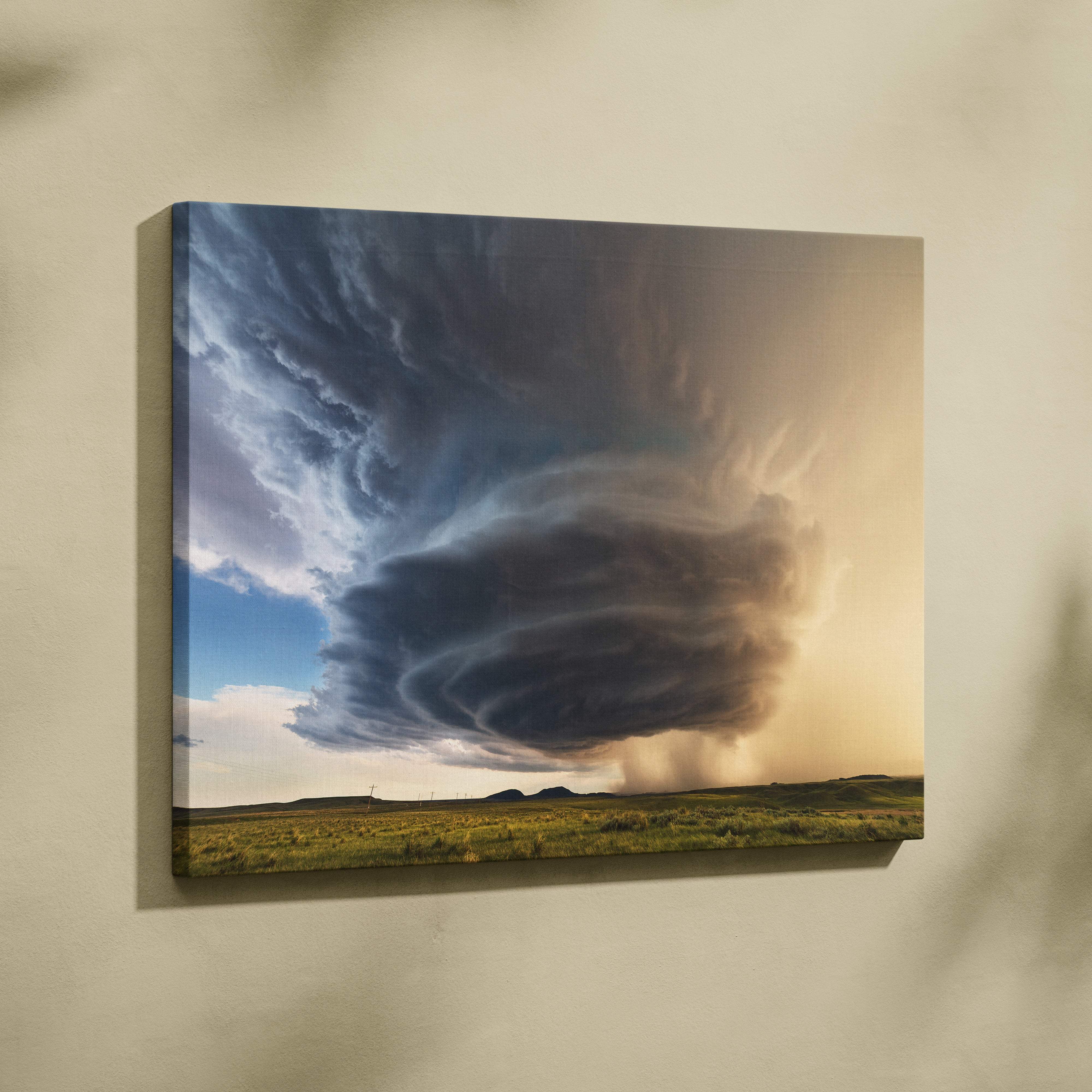 A canvas print of a supercell thunderstorm with dark swirling clouds over a field mounted as dramatic wall decor