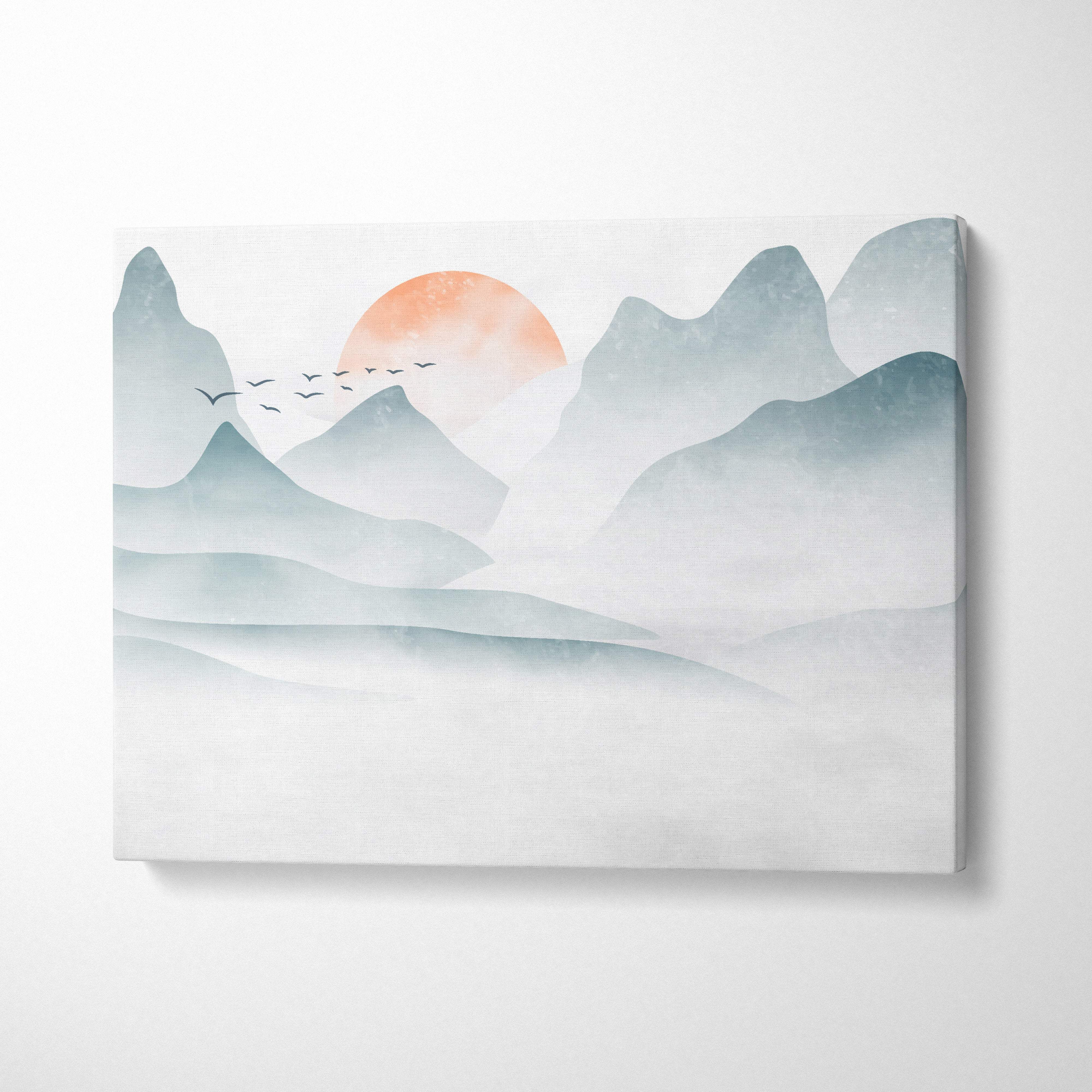 Misty mountain sunrise canvas wall art print with layered teal and gray mountains and warm orange sun for japandi decor