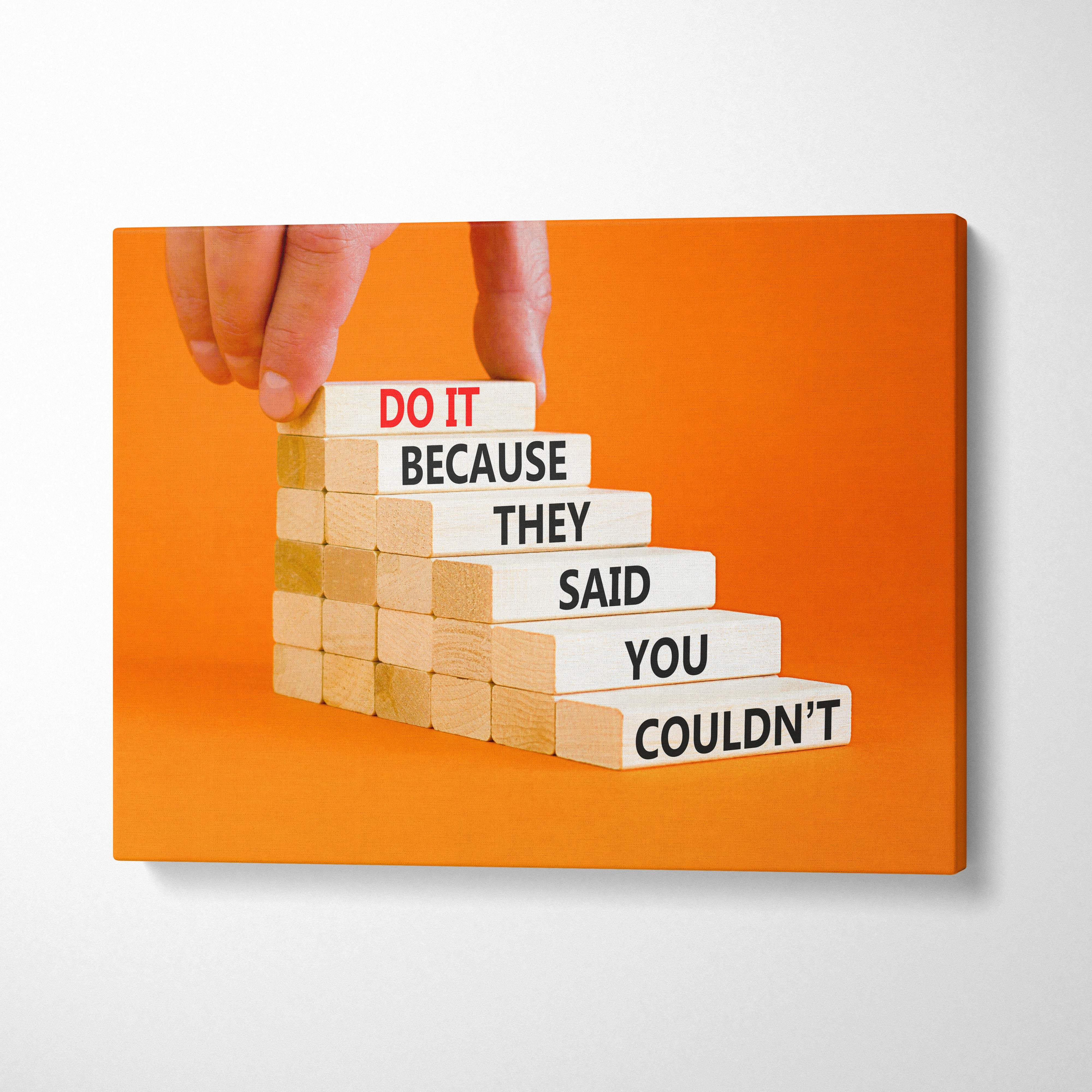 Orange canvas print with motivational text on light wooden blocks for office gym or home decor wall art