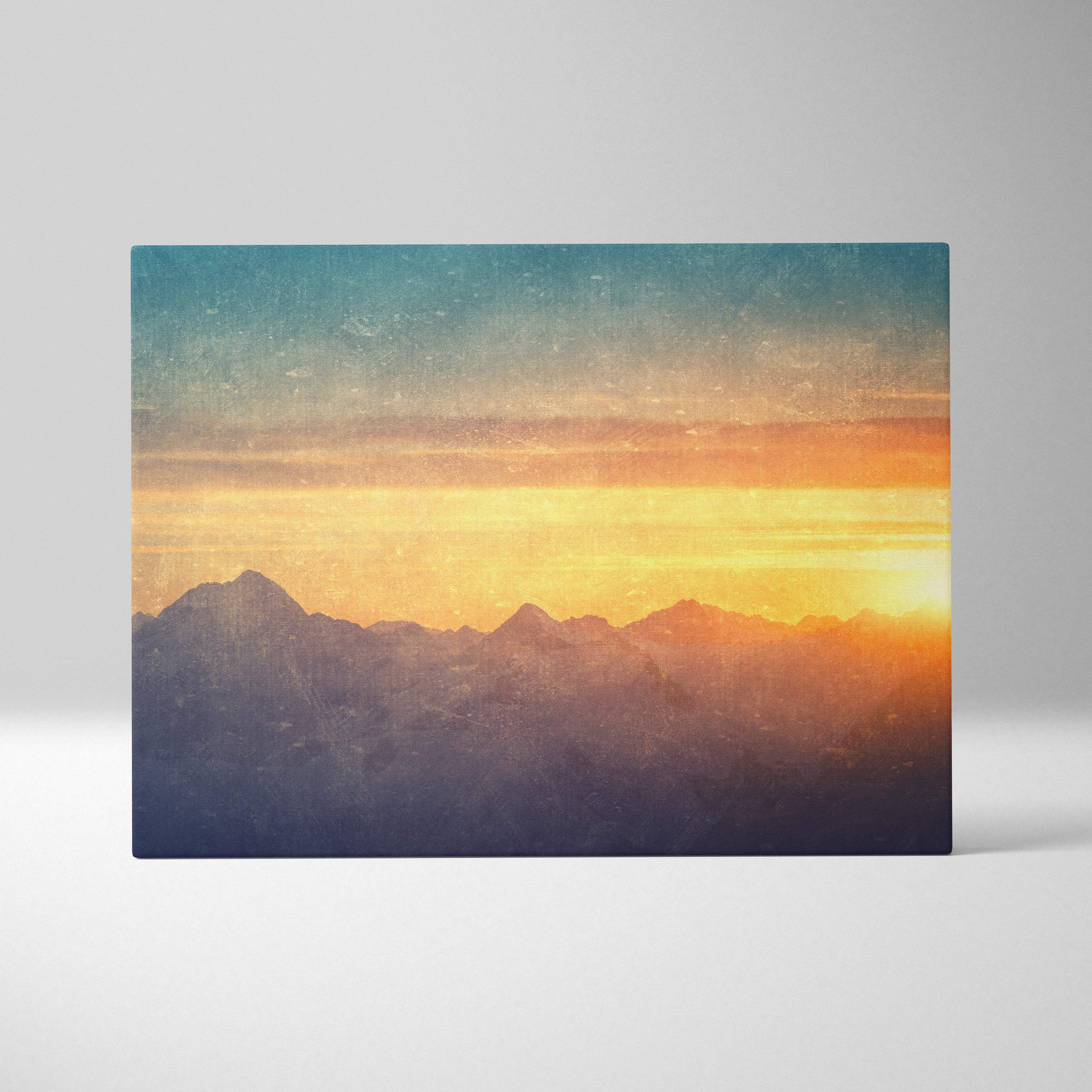 A rectangular canvas print of a golden mountain sunset with teal orange hues for rustic living room decor