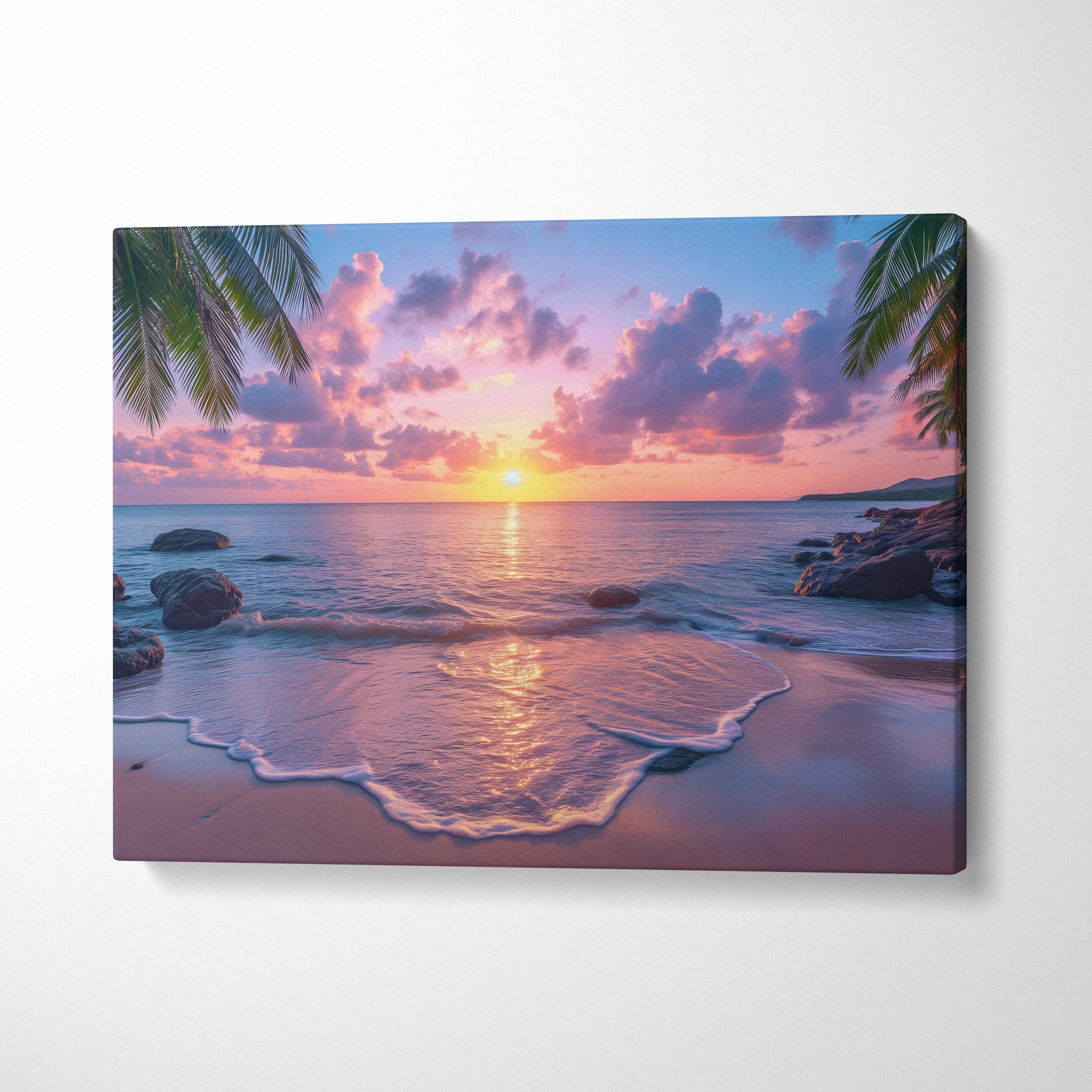 Canvas wall art featuring a vibrant beach sunset with pink, purple, and orange hues, framed by palm leaves and rocks.
